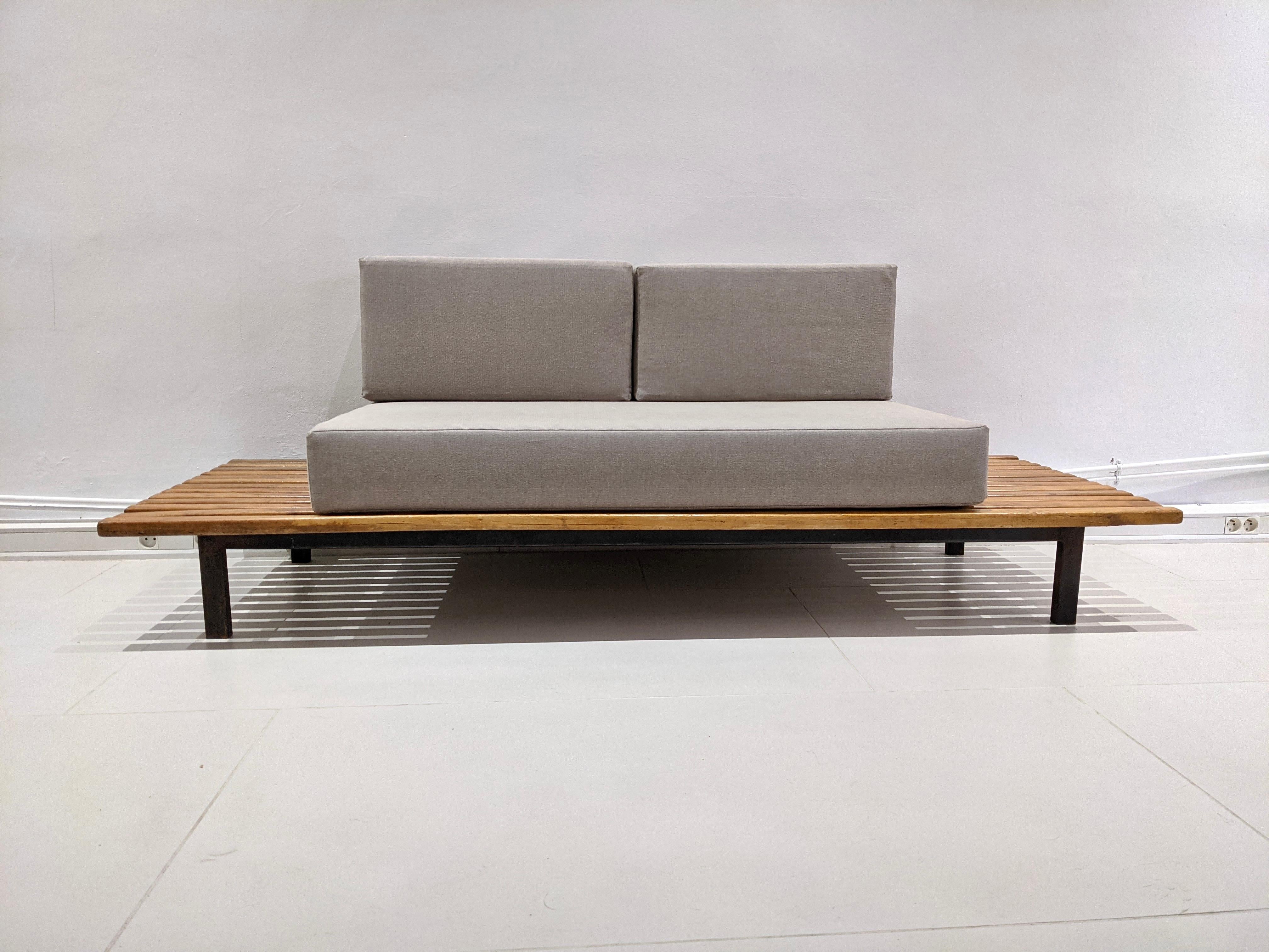 Cansado bench in mahogany tree by Charlotte Perriand, cushions in grey fabric. Year 1954. Edition Steph Simon. Very good condition. Provenance: Cansado mining town, Mauritania, Africa.