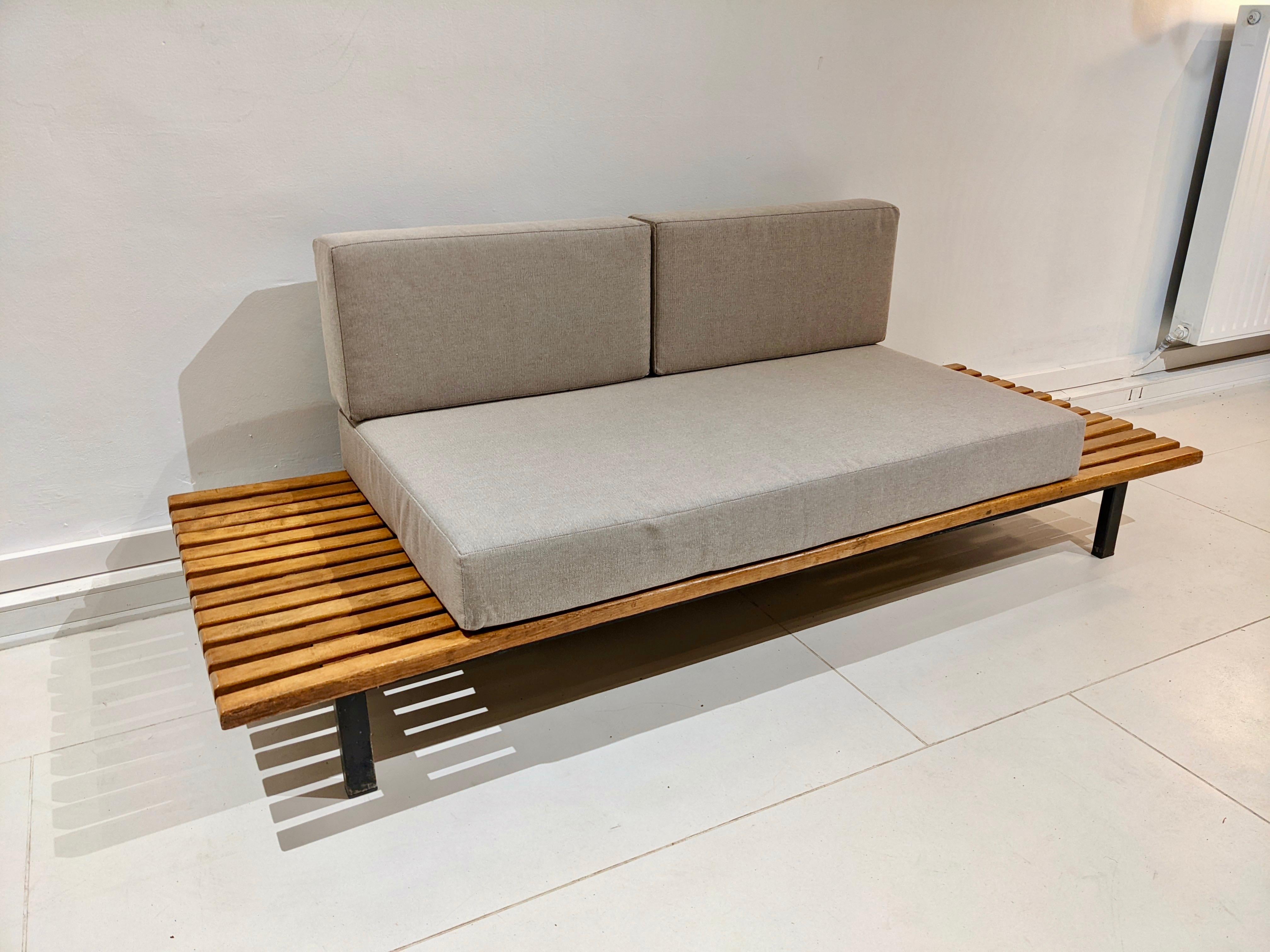 Cansado bench in oak wood and grey fabric cushion by charlotte perriand. Very good condition. The slats have been restored. Edition steph simon. Circa 1954. 
Provenance: cansado mining city, mauritania, africa. 
Dimensions: W 190 cm x D 70 cm x H