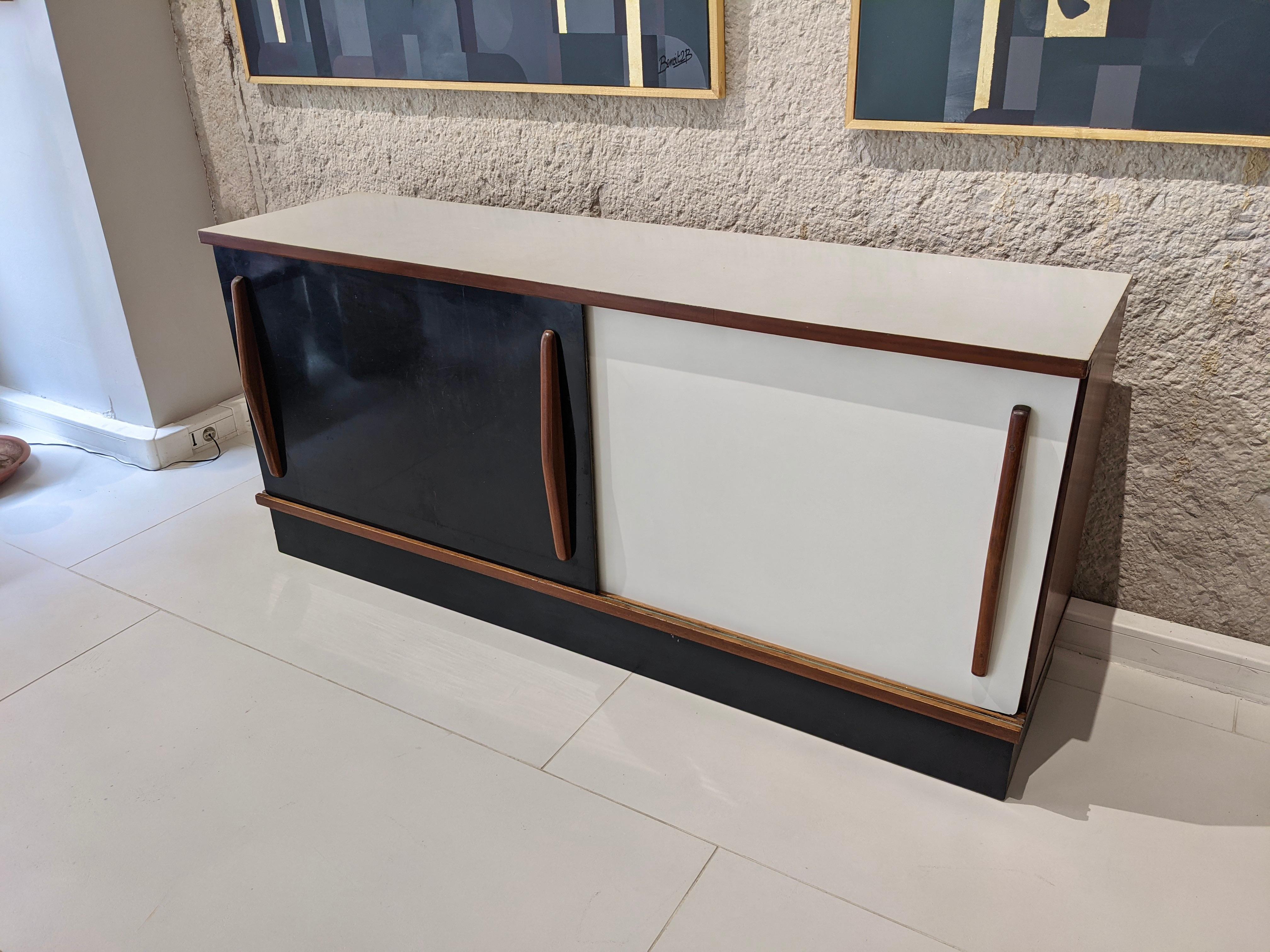Two-door Cansado sideboard by Charlotte Perriand. Mahogany and melamine white and black. 1954. Steph Simon Edition. Very good condition. 
Origin : Mining town of Cansado, Mauritania, Africa.
Dimensions : H41 cm x W150 cm x D68 cm.
