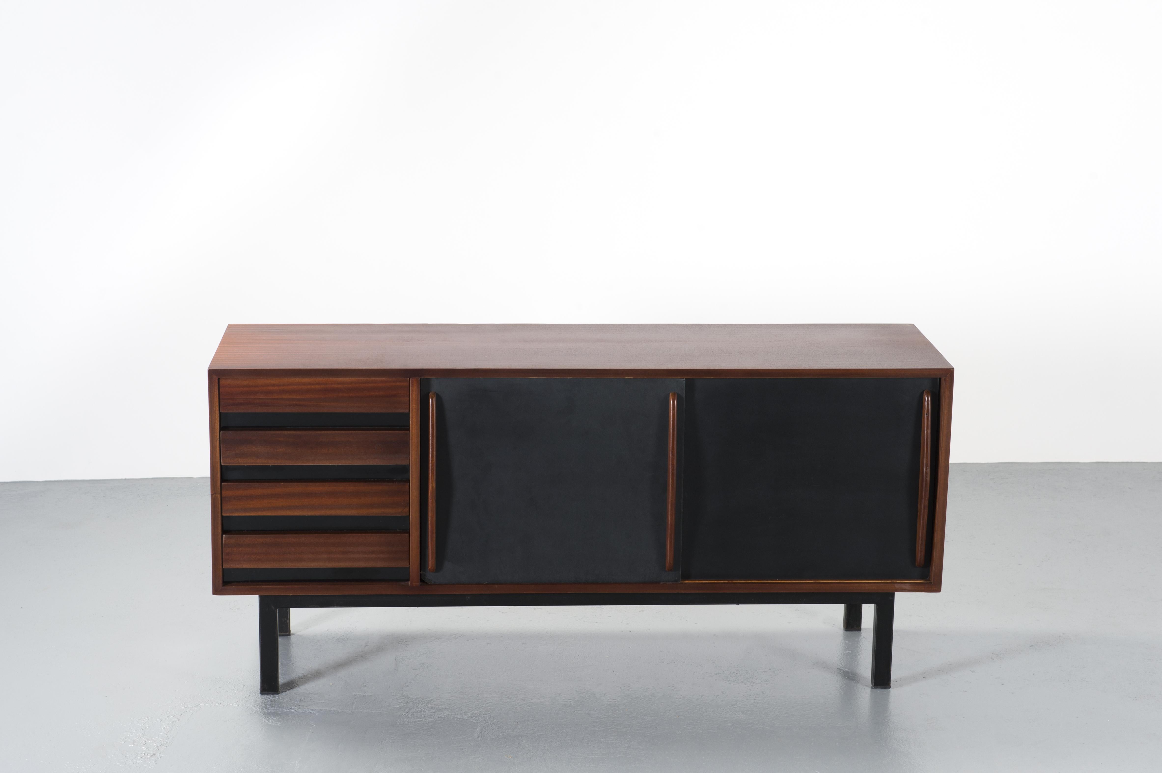 Cansado Mining Town Charlotte Perriand sideboard, circa 1960, Mauritania.

Sideboard in mahogany veneering, two sliding doors in black laminate formica and four drawers on the side. The base is in metal painted black.

Charlotte Perriand is a