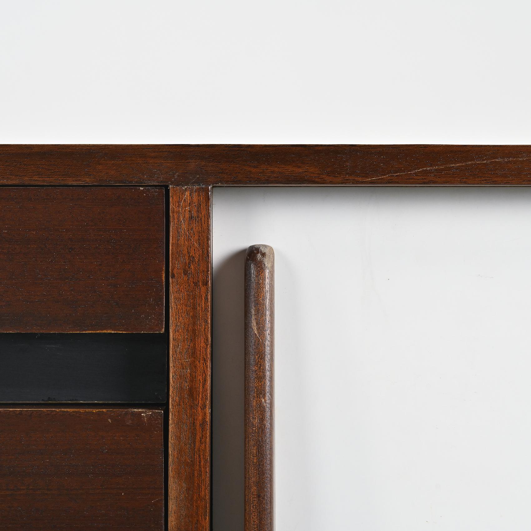  A sideboard by Charlotte Perriand, from the Cansado mining city in Mauritania. 

Structure in mahogany veneer, with two black and white laminate sliding doors, all resting on a black lacquered base. 

Manufacturer: Steph Simon, 1956-1974.
