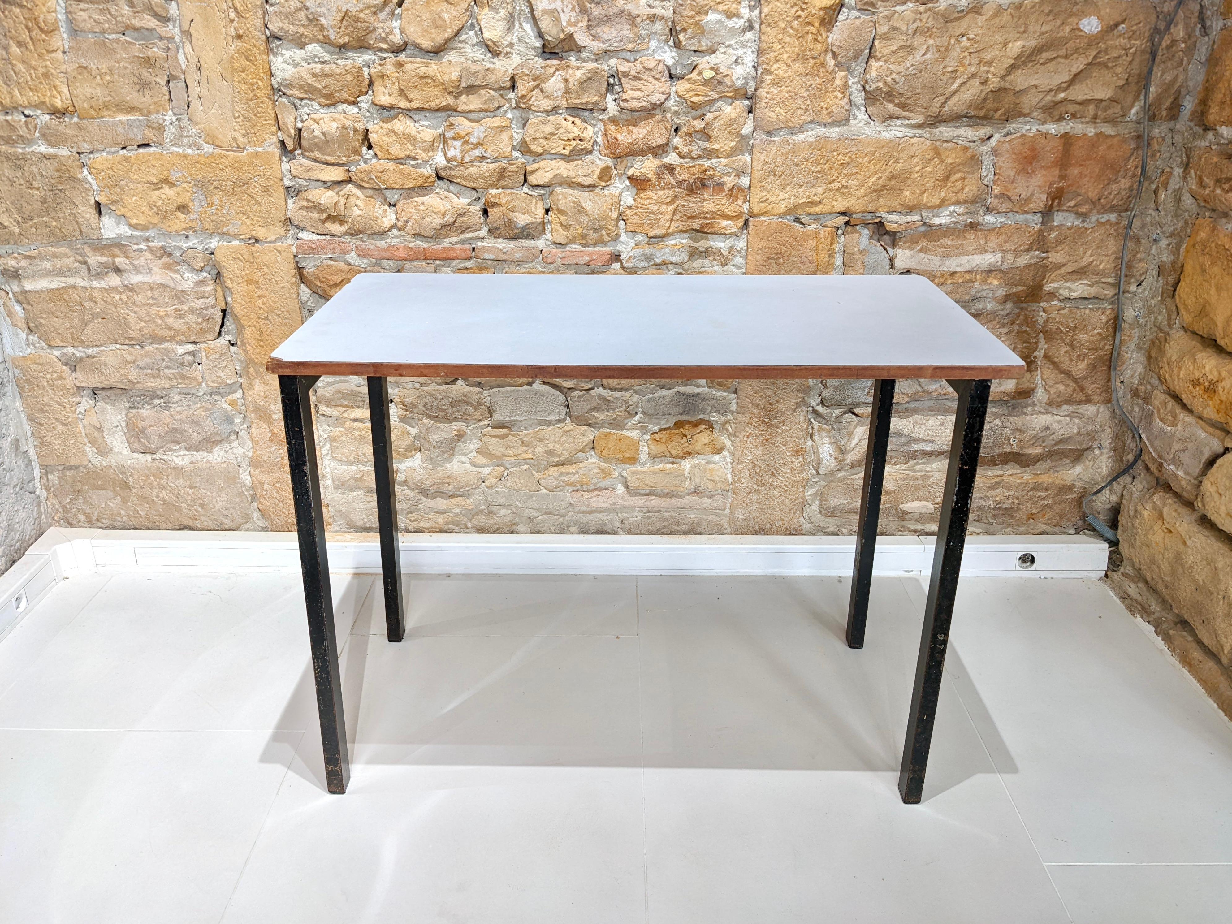 Cansado table by Charlotte Perriand. 
Circa 1950. It consists of a white formica top and a metal base. 
Presence of wear due to age and use (see pictures). 
Provenance : Cansado, Mauritania 

Dimensions : D 50 cm x H 75 x W 100.