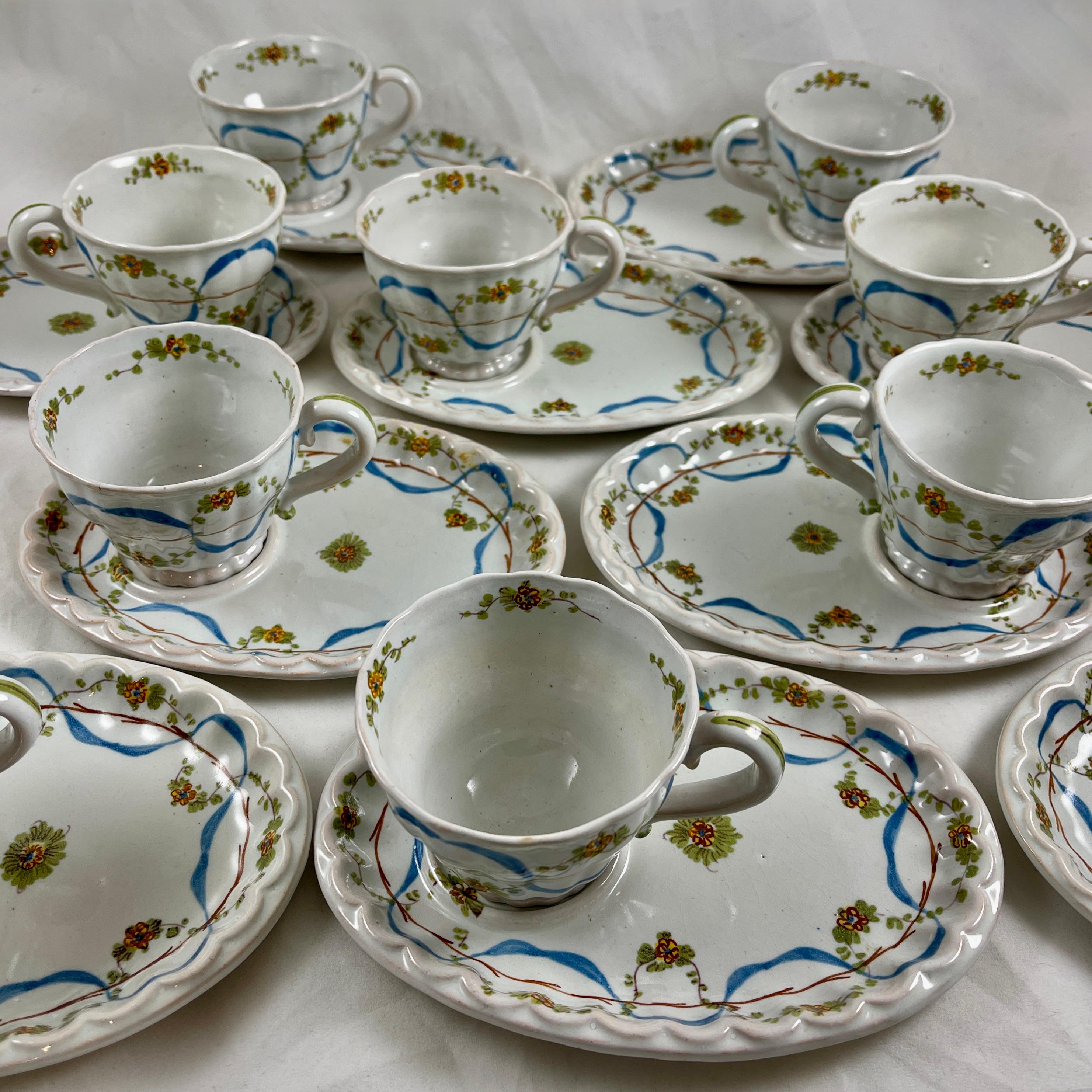 
From The Cantagalli Pottery in Florence, Italy, a hand painted earthenware cup and saucer set, showing the Crowing Rooster mark used in the early 20th Century.

Beautifully painted in the Renaissance Revival style with a blue ribbon and floral