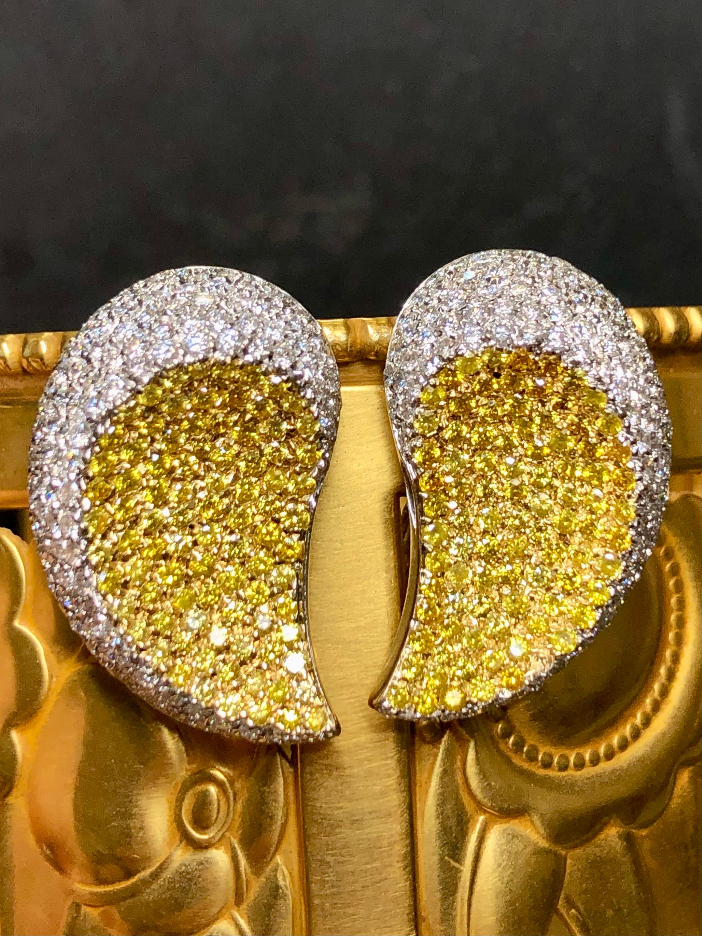 Meticulously crafted earrings by Italian maker, Cantamessa. They are done in 18K white gold and set with approximately 4.50cttw in G-H color Vs1-2 clarity round white diamonds as well as 2.10cttw in fancy intense yellow diamonds (we assume color