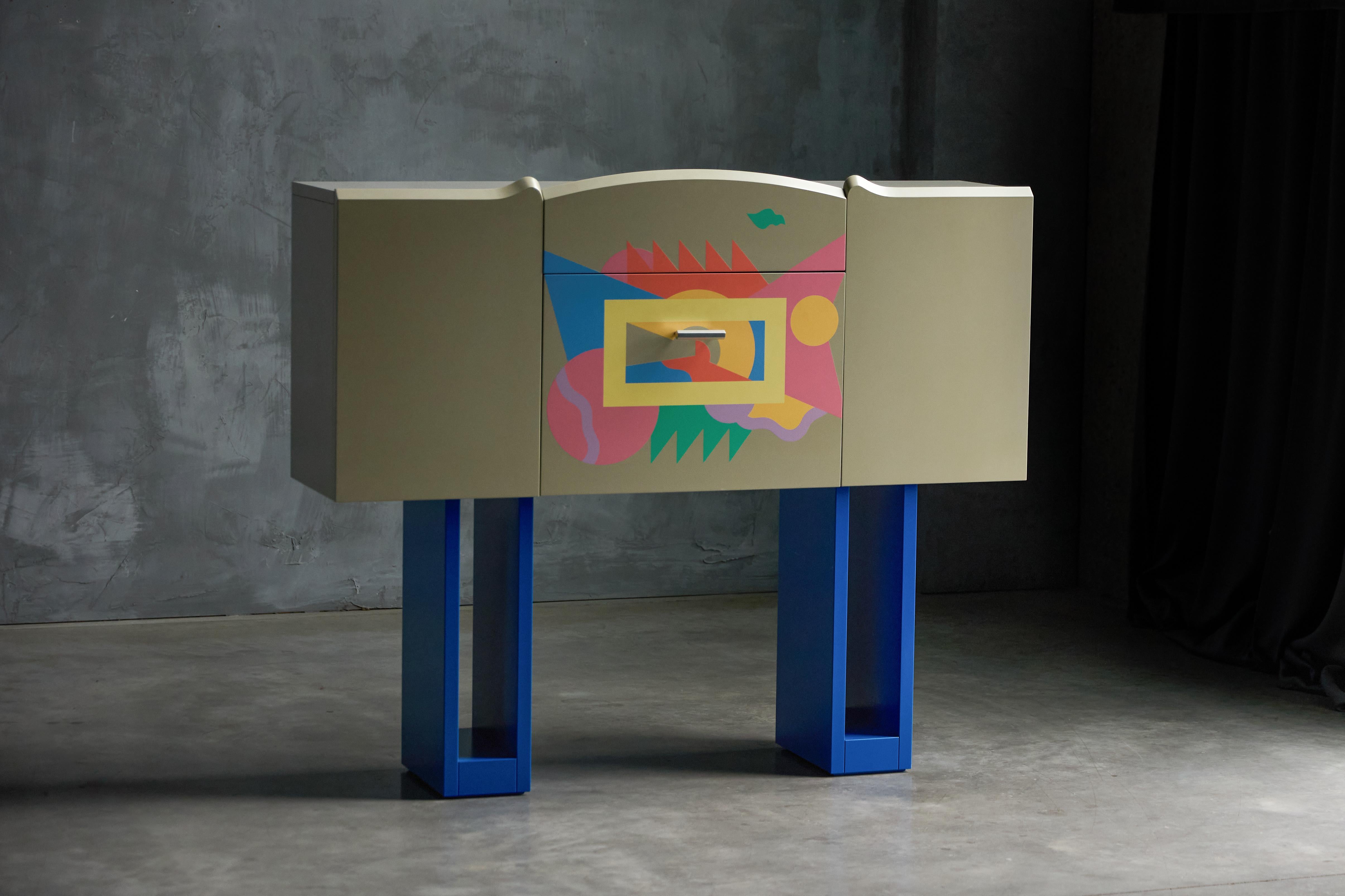 Designed and signed by Italian architect and designer Alessandro Mendini for Zanotta in 1988, the Cantaride Bar-Cabinet is a rare piece from the iconic 1980s Memphis era. The cabinet features a lacquered grey wooden frame with a vibrant hand-painted