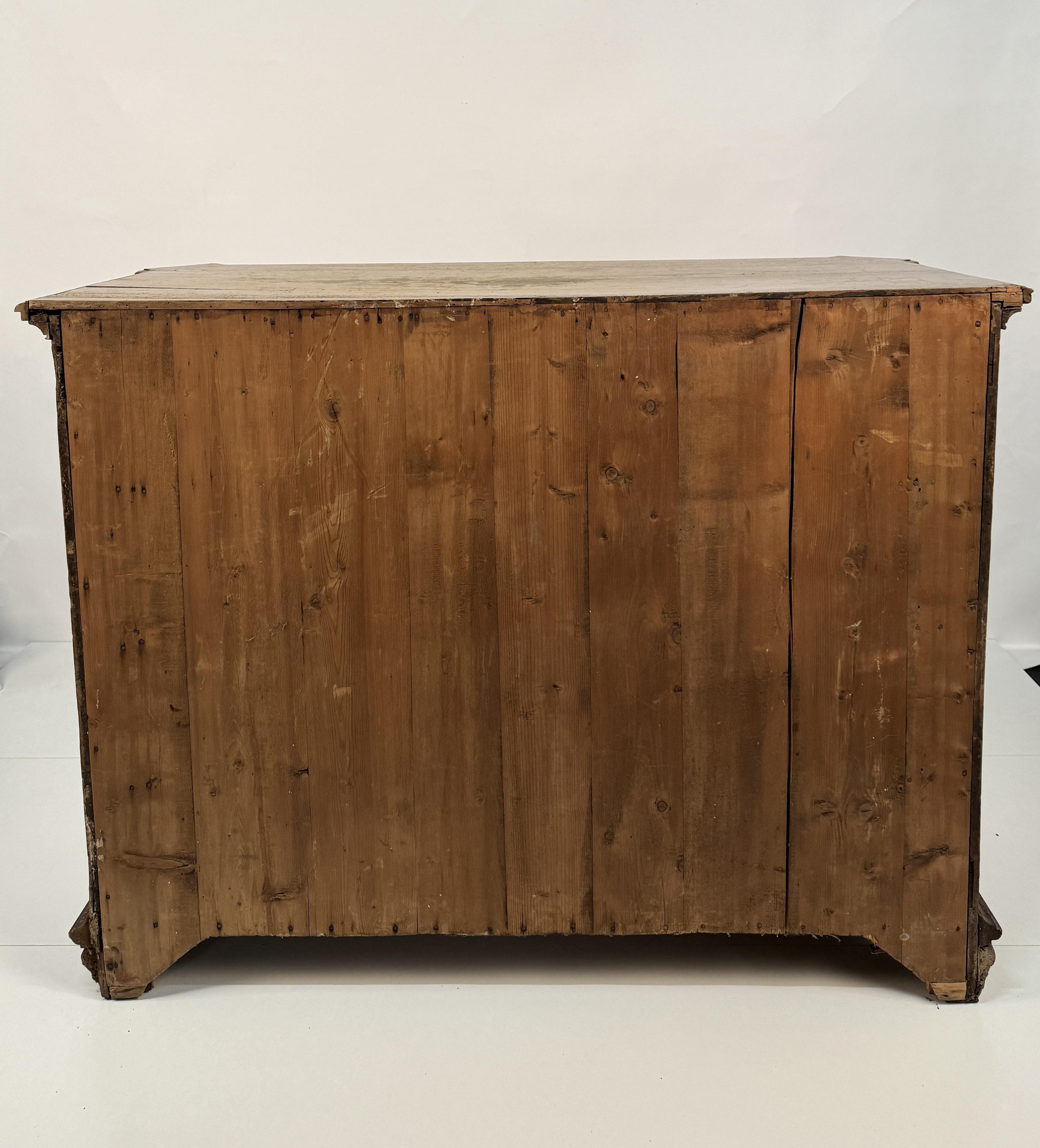 Walnut canterano, Lombardy, 17th century. Front with three drawers separated by transoms and decorated with panels within in-line cornices. Underneath the top is a cove that conceals six small drawers inside. The sides decorated with a mixtilinear