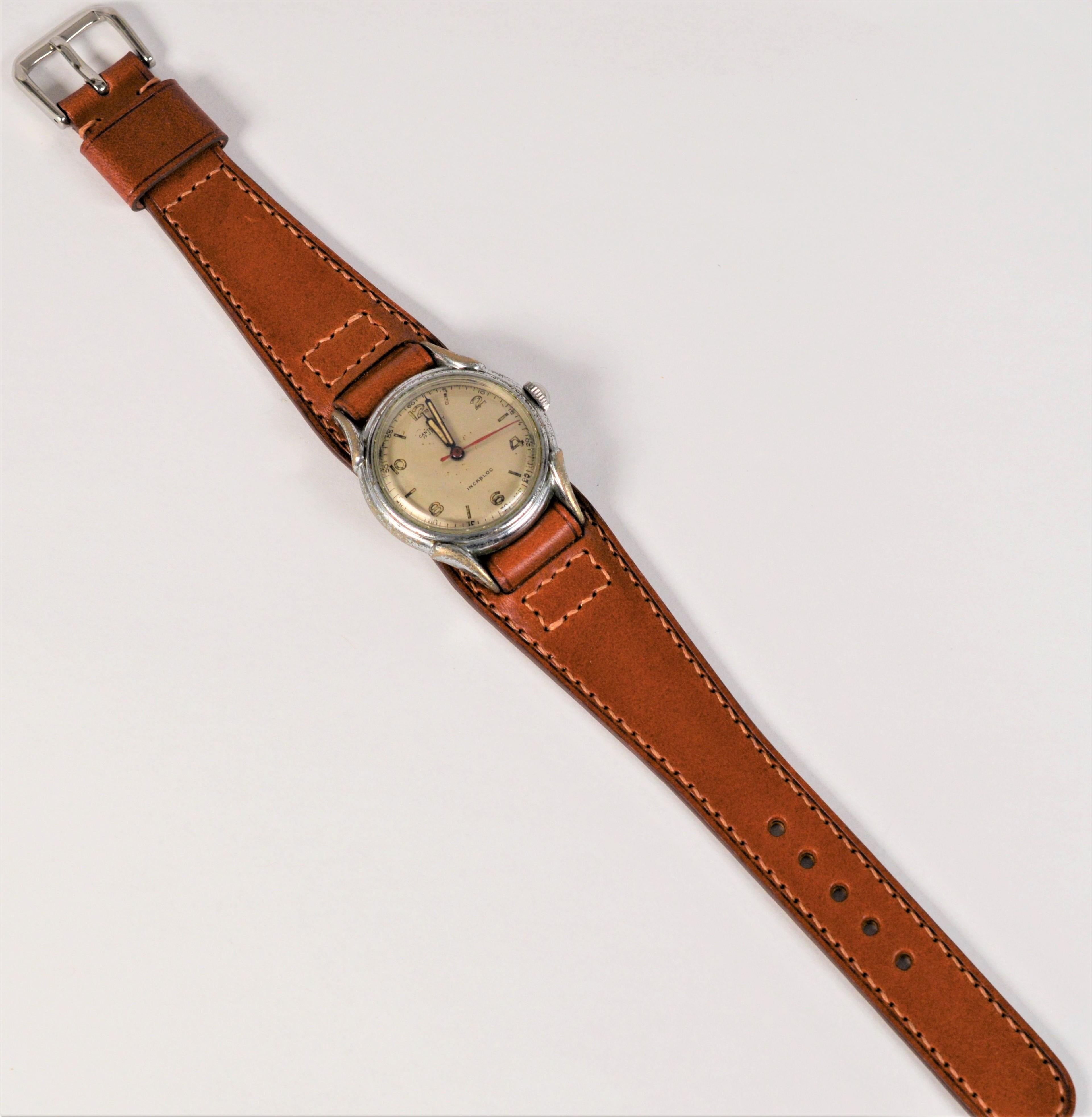 With it's case intentionally left in original condition, proudly showing signs of use from its journey thru time from the Pre-War 11 Era, this vintage American made steel 31mm Canterbury Wrist Watch presents an authentic rugged look and is perfect