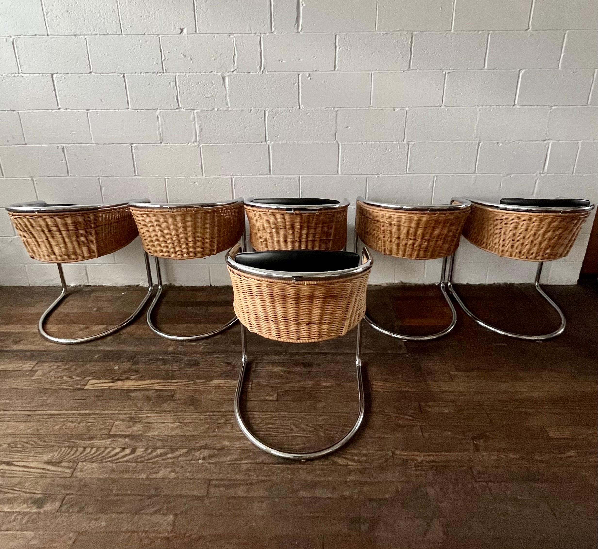 Wonderful chrome and wicker dining chairs. Cantilevered chrome frames with wicker bucket seats. Each with black vinyl seat and back cushion for added visual contrast and comfort. In the manner of Harvey Probber and Anton Lorenz
Curbside to