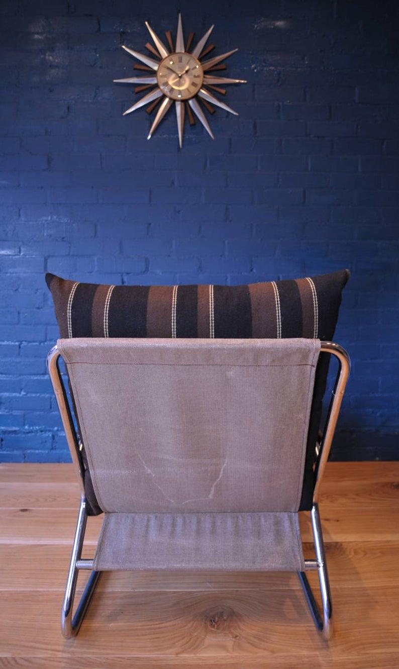 Cantilever Danish tubular chromed lounge armchair with retro striped cushions.