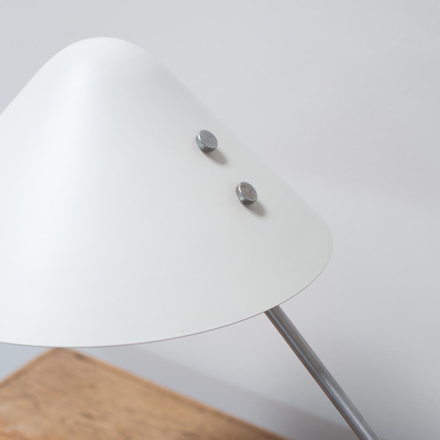 This Danish Modern cantilevered desk lamp by Jørgen Gammelgaard rotates 360 degrees. The light weight white enameled shade and brushed steel arm juxtaposed nicely with the heavy stone base.