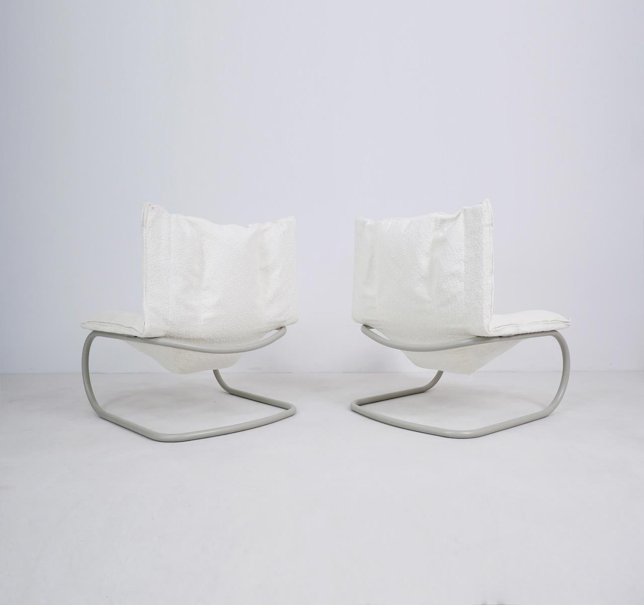 Cantilever lounge chairs designed by Marzio Cecchi, the visionary Firenze born Architect, Designer and Artist. 

The seat of the chairs are upholstered in a light cream boucle and sit on a tubular steel cantilever base. They are extremely