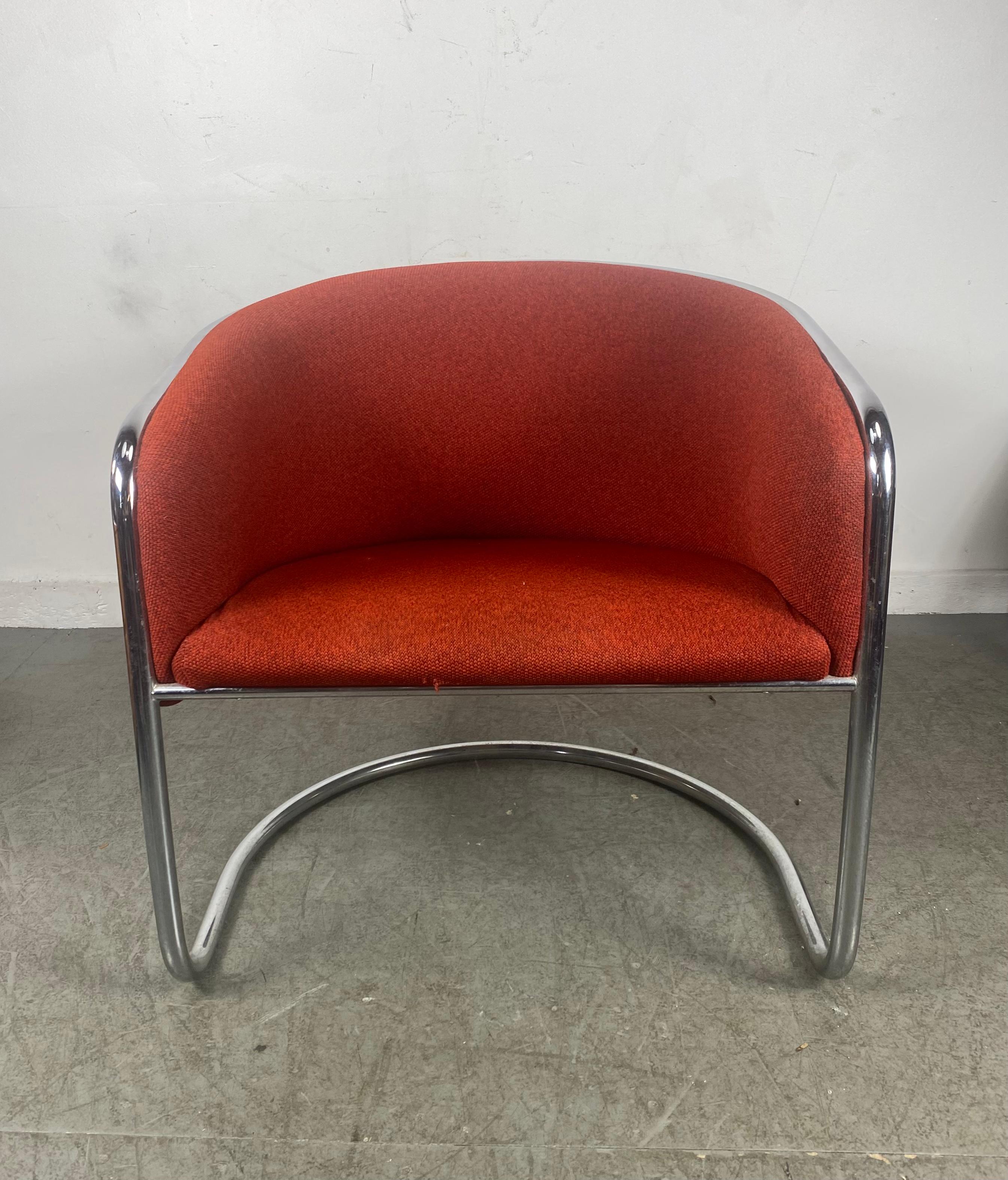 From a design by Joan Burgasser and Anton Lorenz, these Thonet Club Tub armchairs set deeply contoured barrel-back seats, Retains original knoll fabric in a vibrant red, within tubular chrome cantilevered frames.: Hand delivery avail to New York