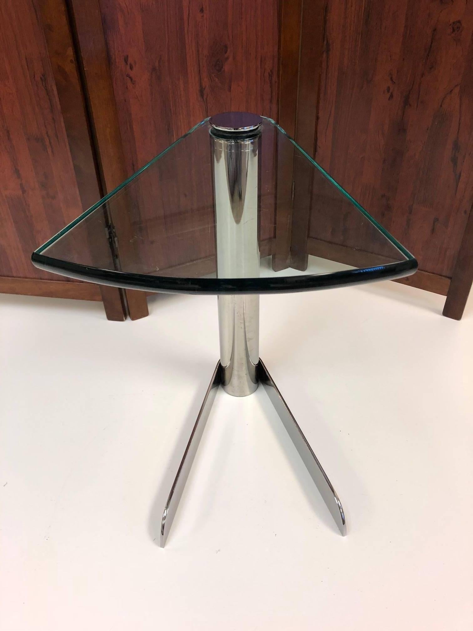 Cantilevered side table with a glass top and chrome frame. 