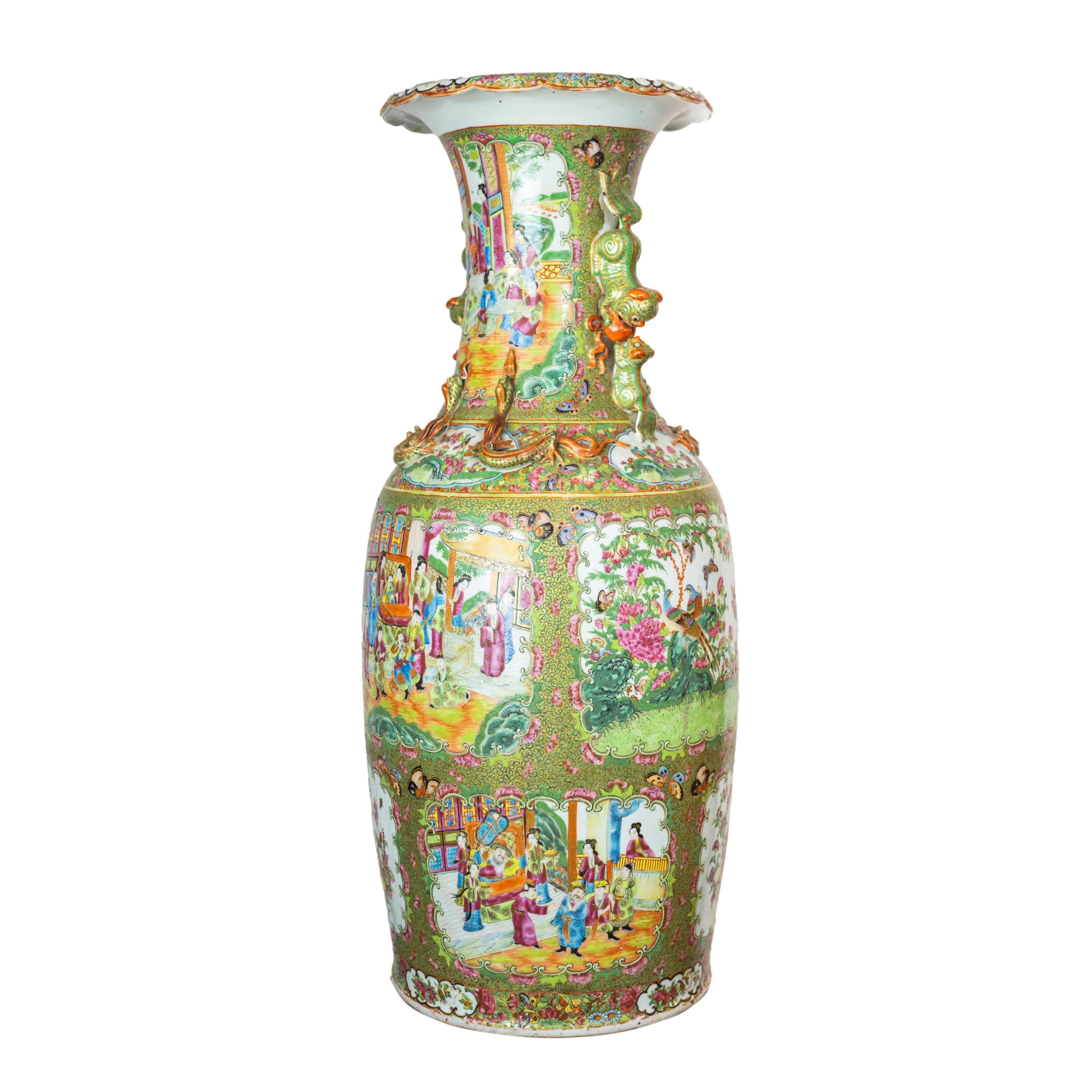 A large Canton Famille rose baluster vase, of baluster form, with a tall waisted neck, an everted scalloped rim, the neck and shoulders with applied paired confronting Foo lions and cubs forming the handles, the shoulders with enameled and gilded