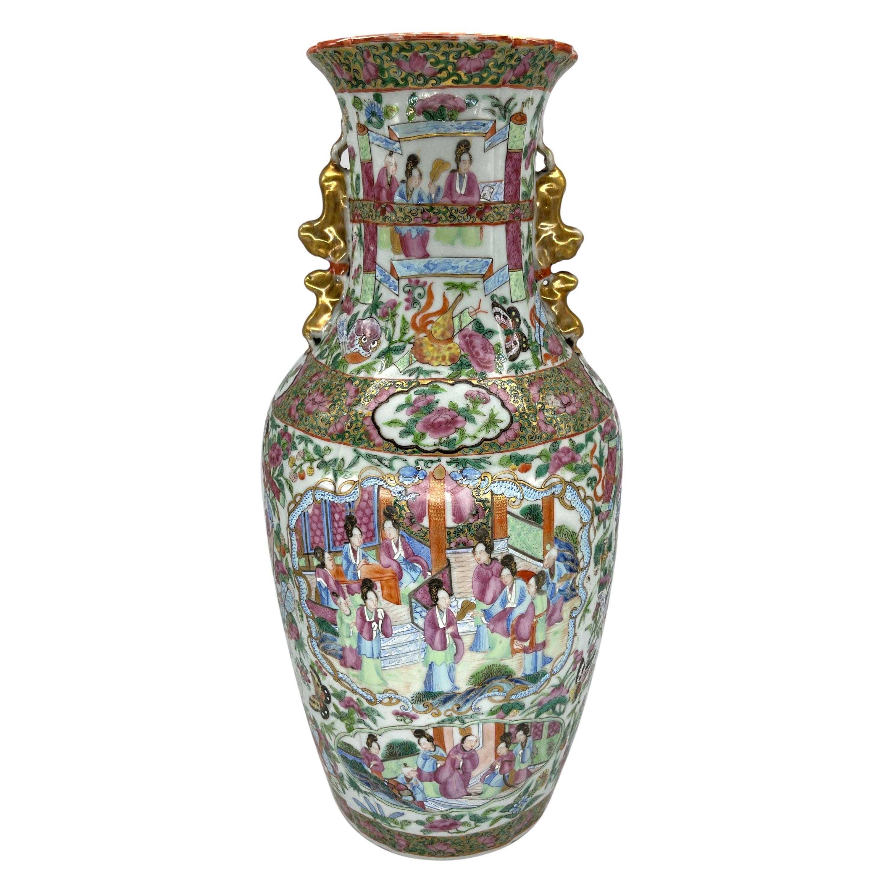 Canton Famille Rose Mandarin pattern shaped vase, the waisted neck with a castellated or linen fold neck and rim, the interior rim decorated with four iron red and gilded bats, the neck and shoulders with applied paired confronting Foo lions and