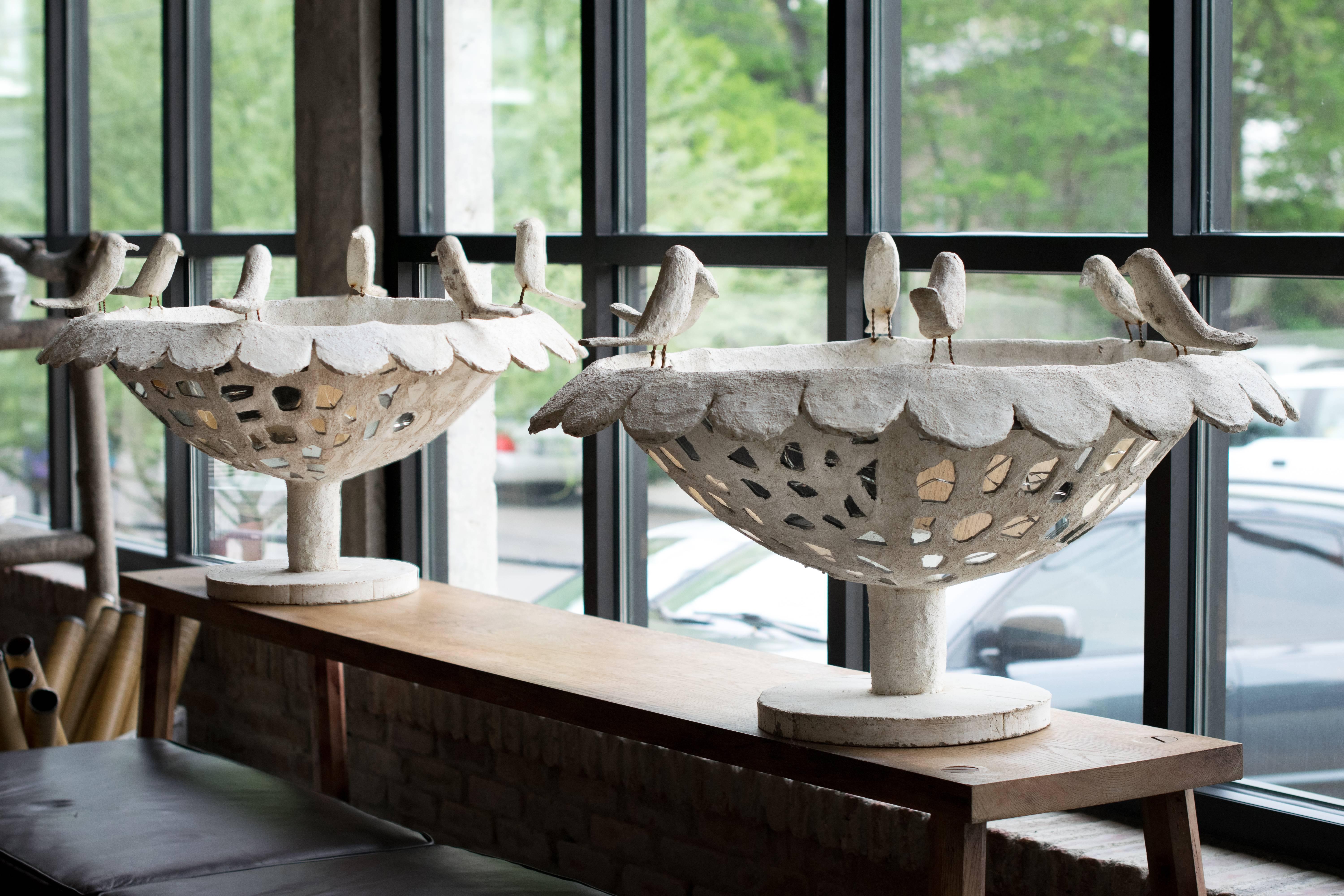 Beauty and whimsy expressed in this highly collectable pair of 3' birdbaths / sculptures by Cantral Valdez, mid-century masonry sculptor from San Antonio, Texas.  Whitewashed cement over wire with inlayed mirrors. Second pair available with fully