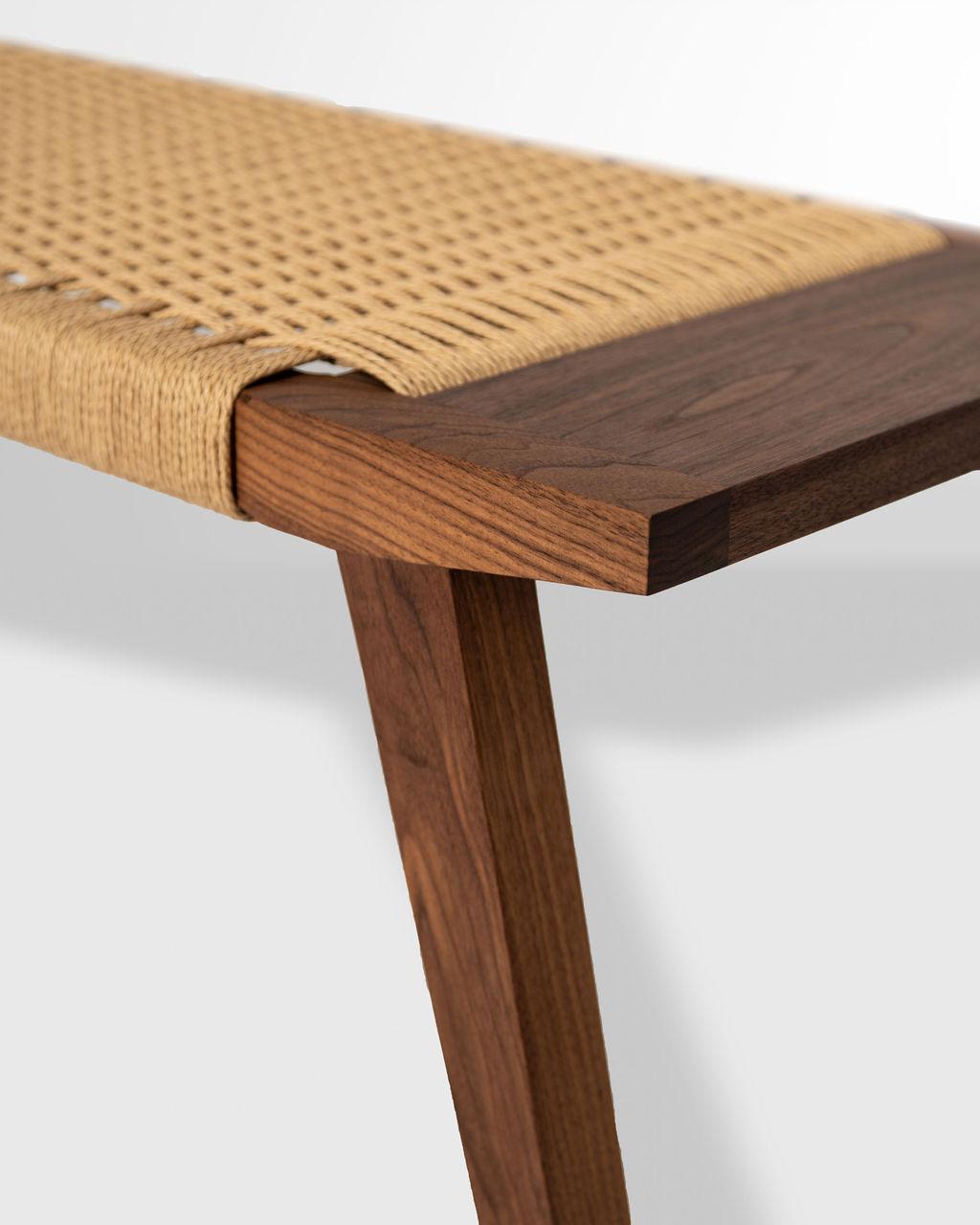 Featuring woven paper cord, walnut, and modest tapers the Canva bench explores a love for material and craftsmanship welded with warm welcome. Constructed with a mortice and Tenon frame and handwoven seat, the Canva bench is artisan-crafted from