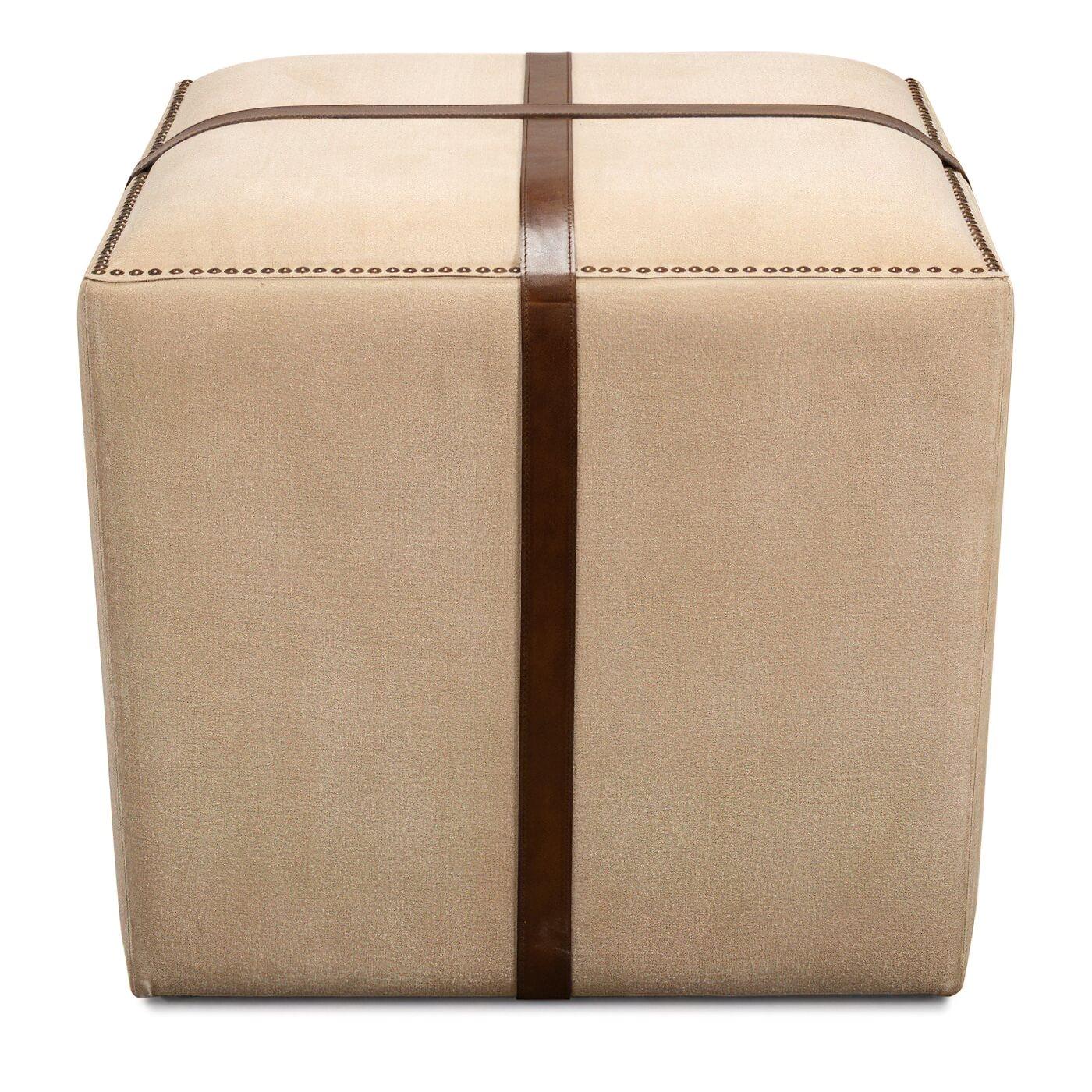 A canvas and leather strap ottoman with nailhead trim accents. The classic cube design makes it a perfect transitional piece of furniture to use as an ottoman or stool. 

Dimensions 
24 in. W x 24 in. D x 20 in. H.
 