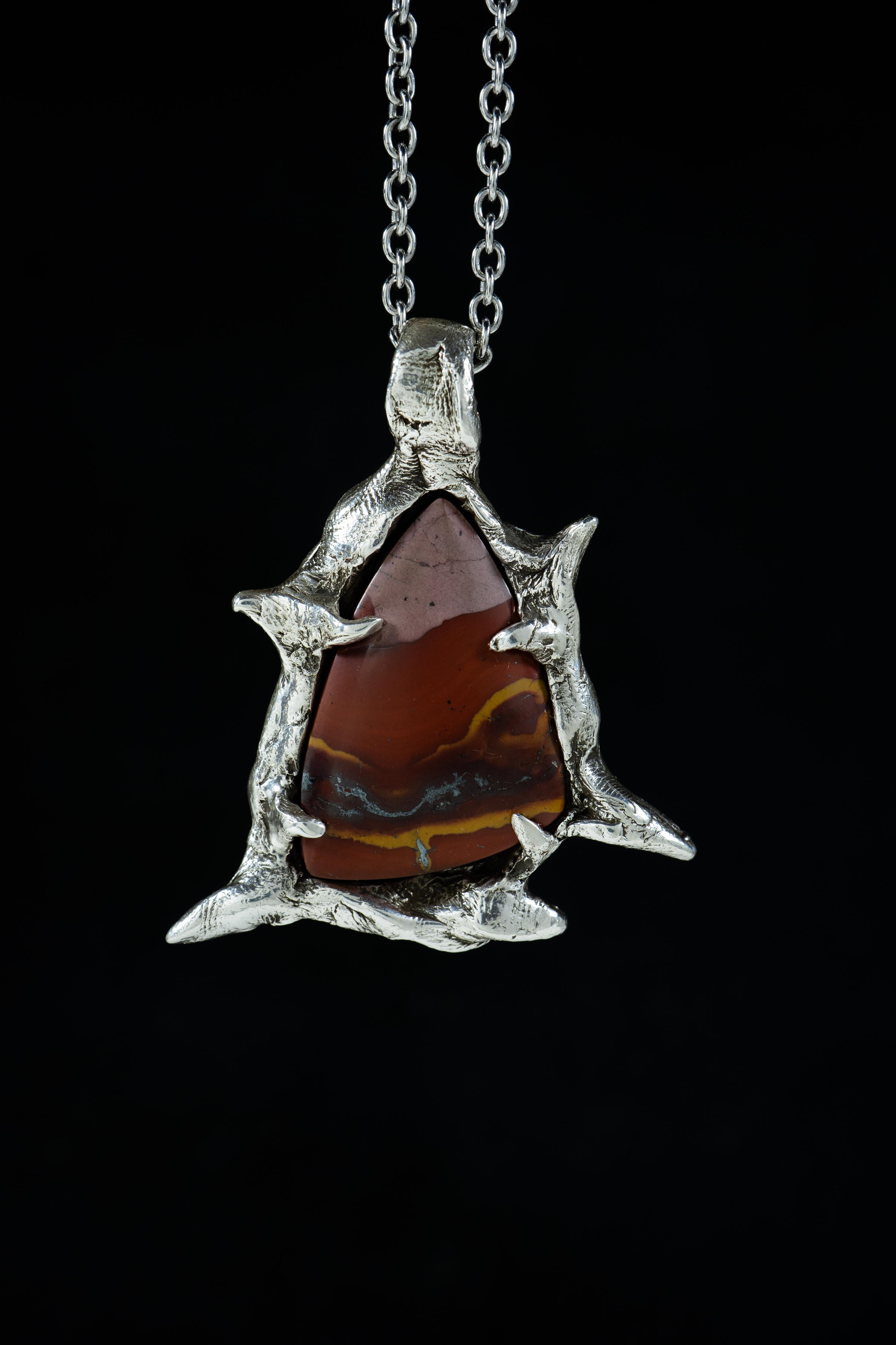 Canyon and the Star is a one-of-a-kind pendant by Ken Fury that is hand-carved and cast in sterling silver and features a natural Red & Green Blanket Jasper from Peru.

Size of piece: 58mm x 50mm

Hand-signed

Includes a 24-inch sterling silver