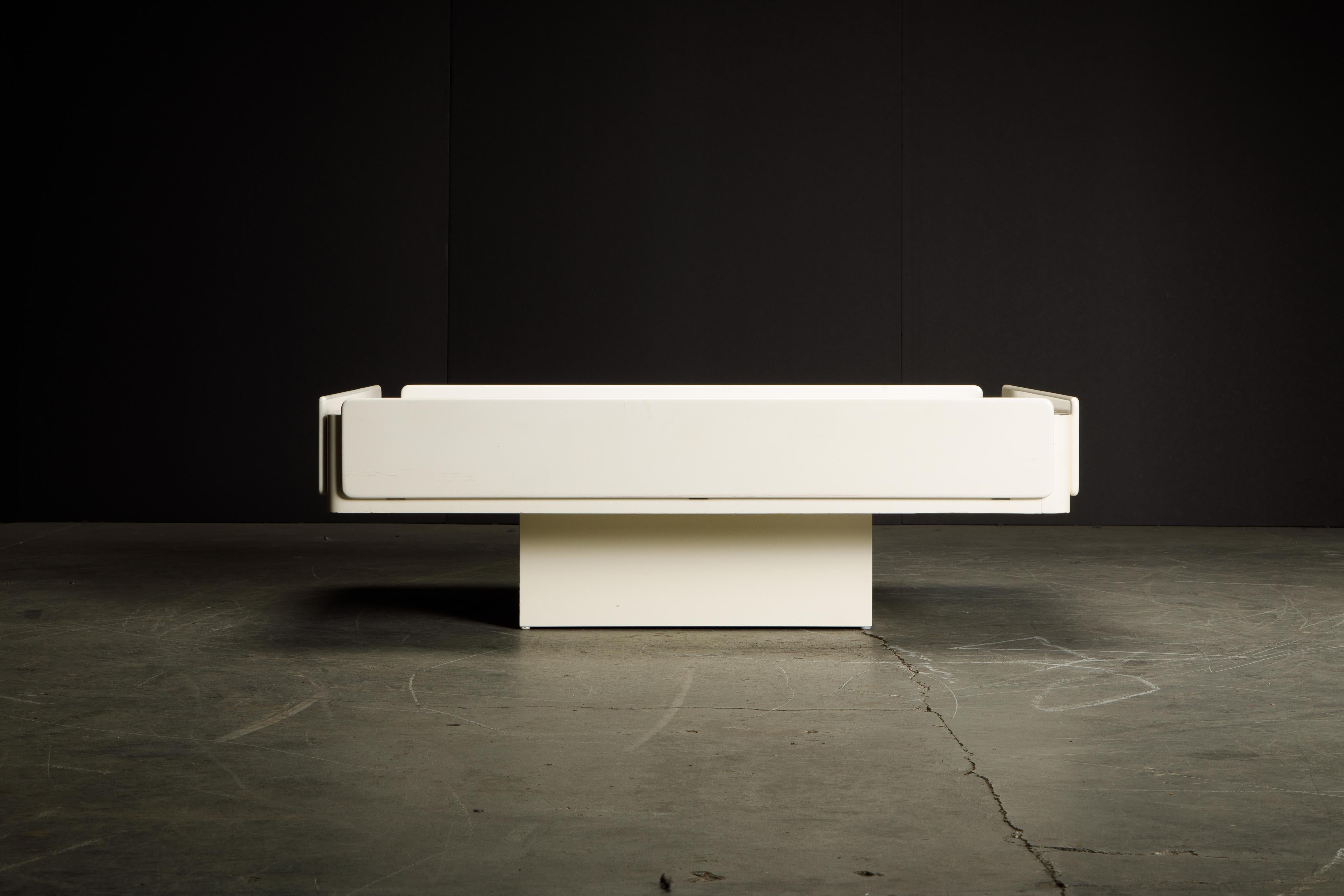 Sleek, cool, functional and elegantly constructed coffee table attributed to the 'Caori' coffee table by Vico Magistretti for Gavina, Italy designed in 1962, in a white lacquered finish with brushed steel top.

This broadly proportioned cocktail