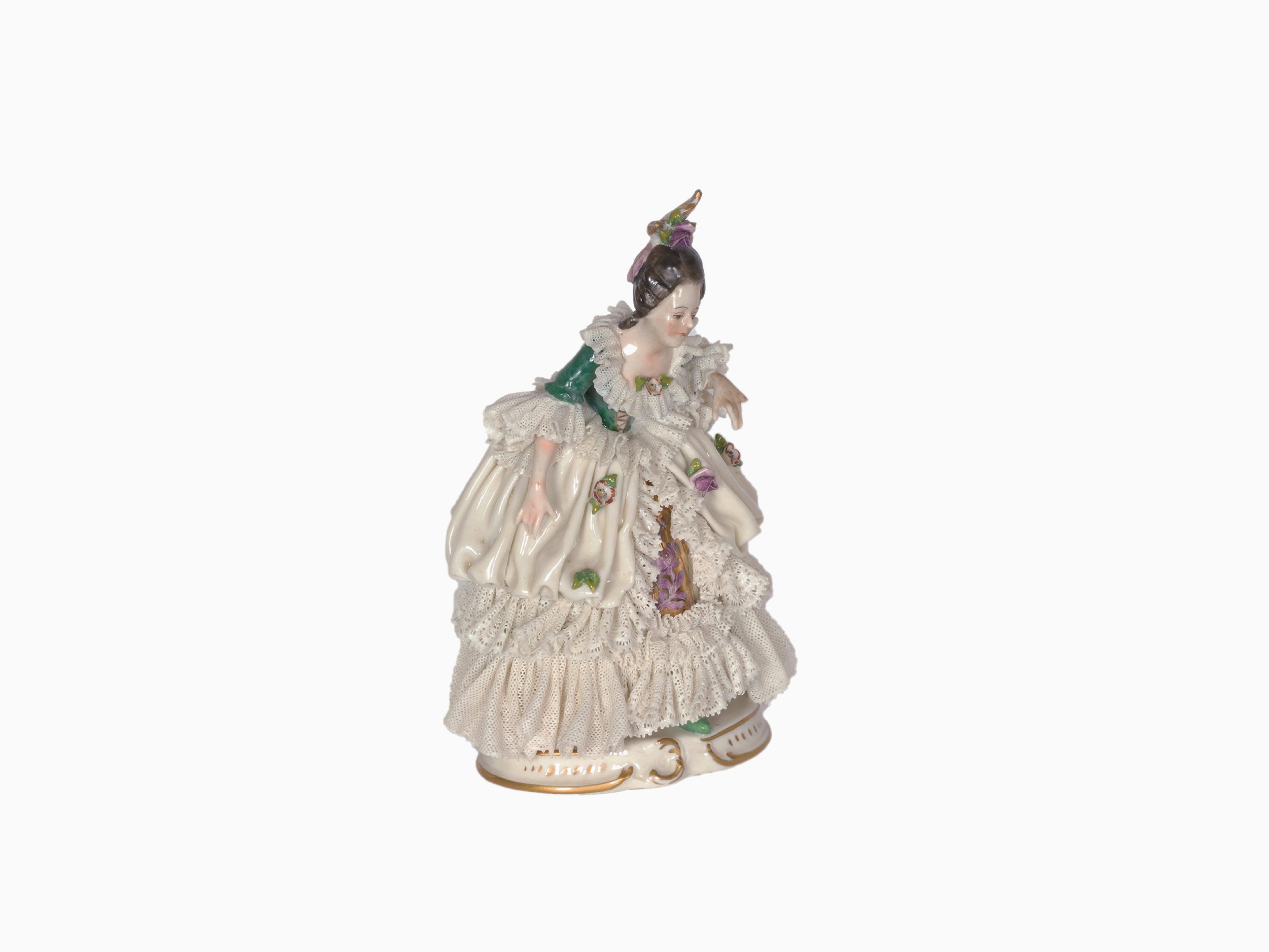 A charming italian porcelain figure of a lady carrying roses