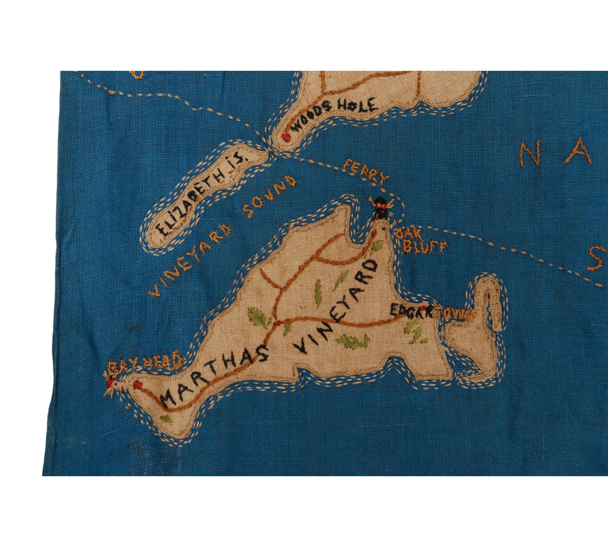 A hand embroidered wall hanging of the Cape Cod peninsula. Depicts Cape Cod, Nantucket Sound, Nantucket and Martha's Vineyard, and the Atlantic Ocean. Details towns, roads, lighthouses and the ferry route. The blue water replete with boats,