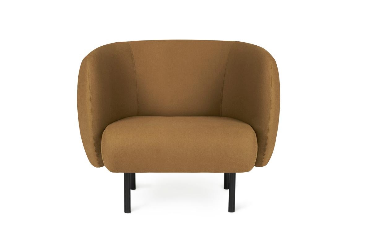 Cape Lounge chair olive by Warm Nordic
Dimensions: D90 x W82 x H 80 cm
Material: Textile upholstery, Wooden frame, Powder coated black steel legs
Weight: 34.5 kg
Also available in different colours and finishes. 

An elegant armchair with an