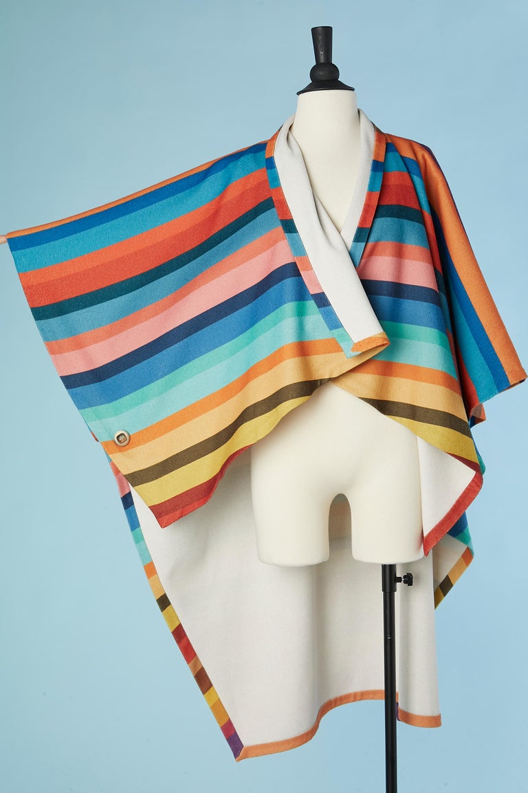 Cape with multicolor striped pattern. Decorative's buttons on the side 
 Size fits.