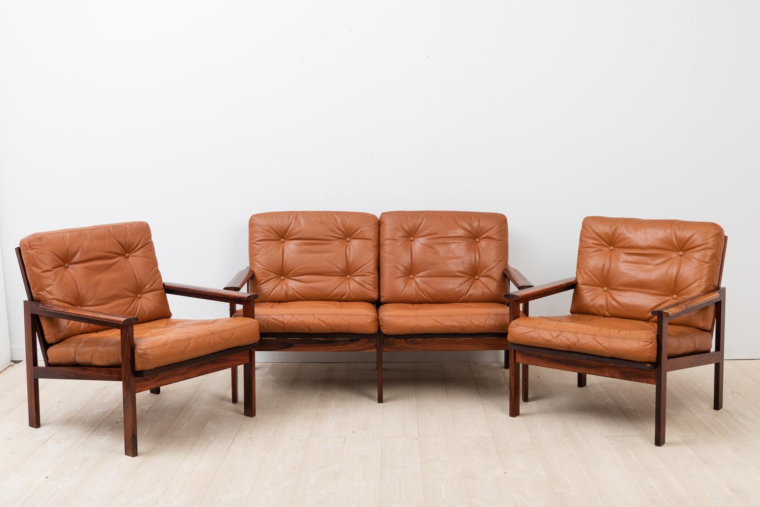 Capella sofa group designed by Illum Wikkelsø 1959. Produced in Denmark by Niels Eilersen. Solid rosewood frame with loose cushions in original leather. The rubber elastics in the seats are new. Cites certificate is available. The group is marked