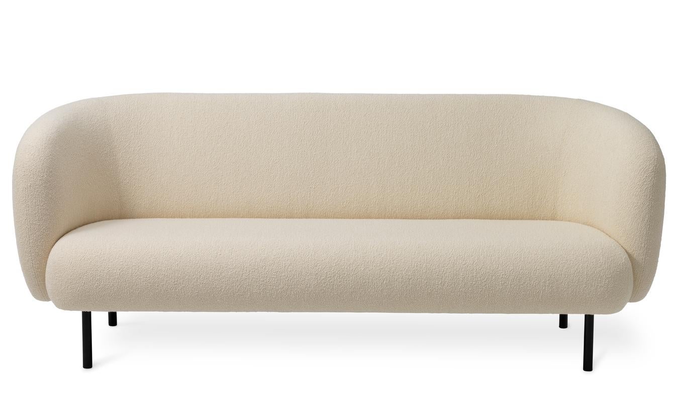 Caper 3 seater cream by Warm Nordic
Dimensions: D 206 x W 84 x H 63 cm
Material: Textile upholstery, Wooden frame, Powder coated black steel legs.
Weight: 55.5 kg
Also available in different colours and finishes.

An elegant sofa with an