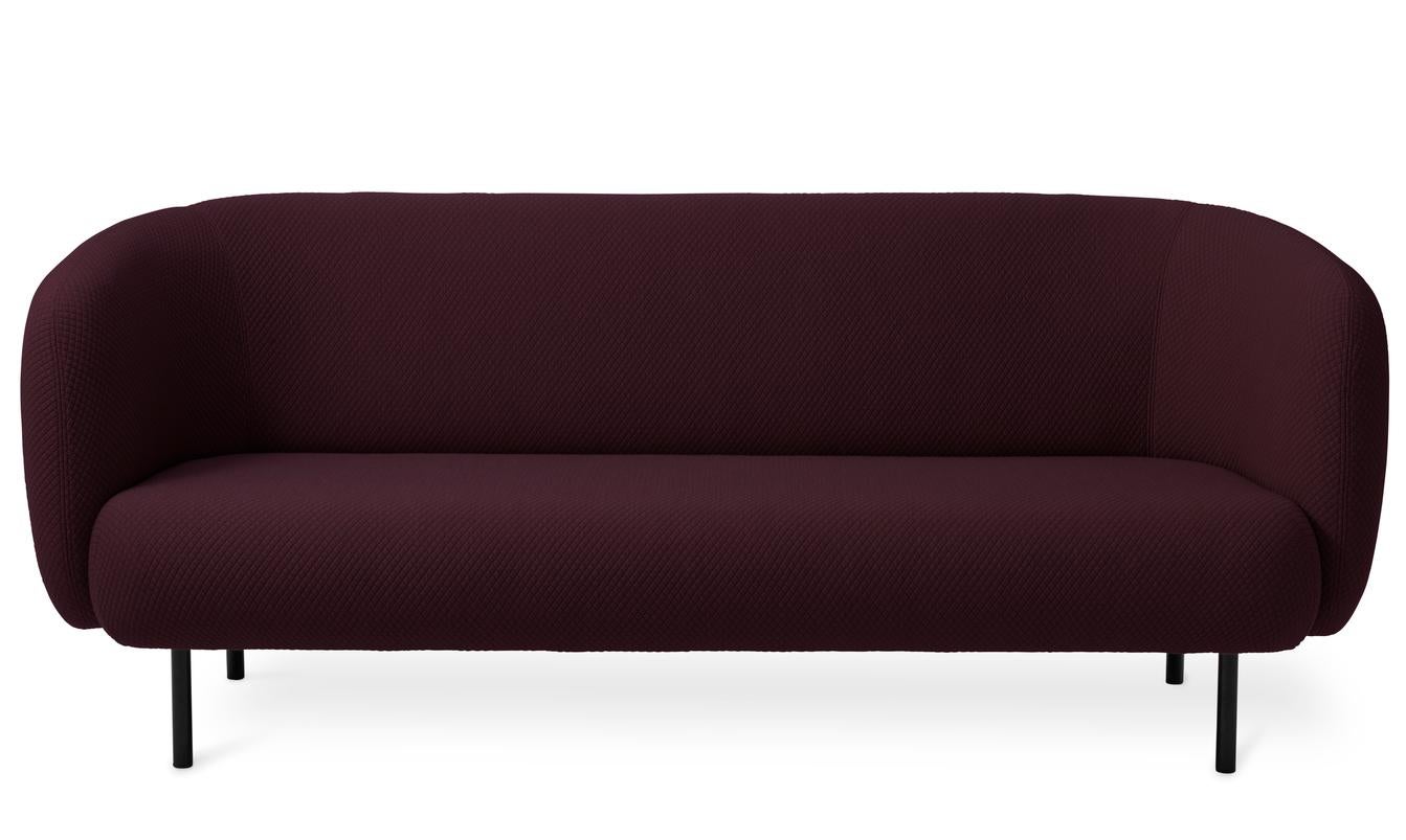 Caper 3 seater Mosaic Dark Bordeaux by Warm Nordic
Dimensions: D206 x W84 x H 63 cm
Material: textile upholstery, wooden frame, powder coated black steel legs.
Weight: 55.5 kg
Also available in different colours and finishes. 

An elegant sofa