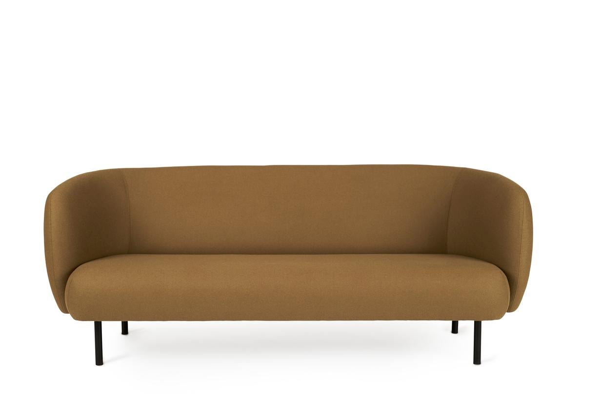 Caper 3 seater olive by Warm Nordic
Dimensions: D206 x W84 x H 63 cm
Material: textile upholstery, wooden frame, powder coated black steel legs.
Weight: 55.5 kg
Also available in different colours. 

An elegant sofa with an organic design