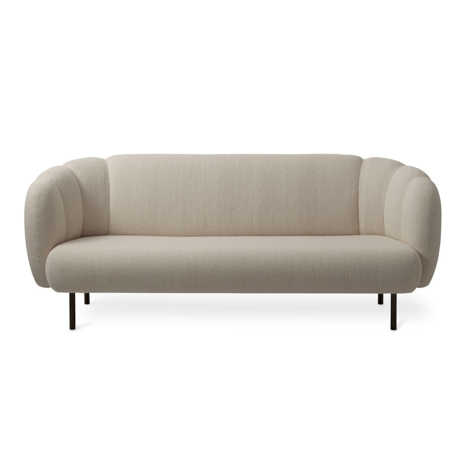 Caper 3 seater with stitches sand by Warm Nordic
Dimensions: D 200 x W 84 x H 80 cm
Material: Textile upholstery, Wooden frame, Powder coated black steel legs.
Weight: 55.5 kg
Also available in different colours and finishes.

An elegant sofa