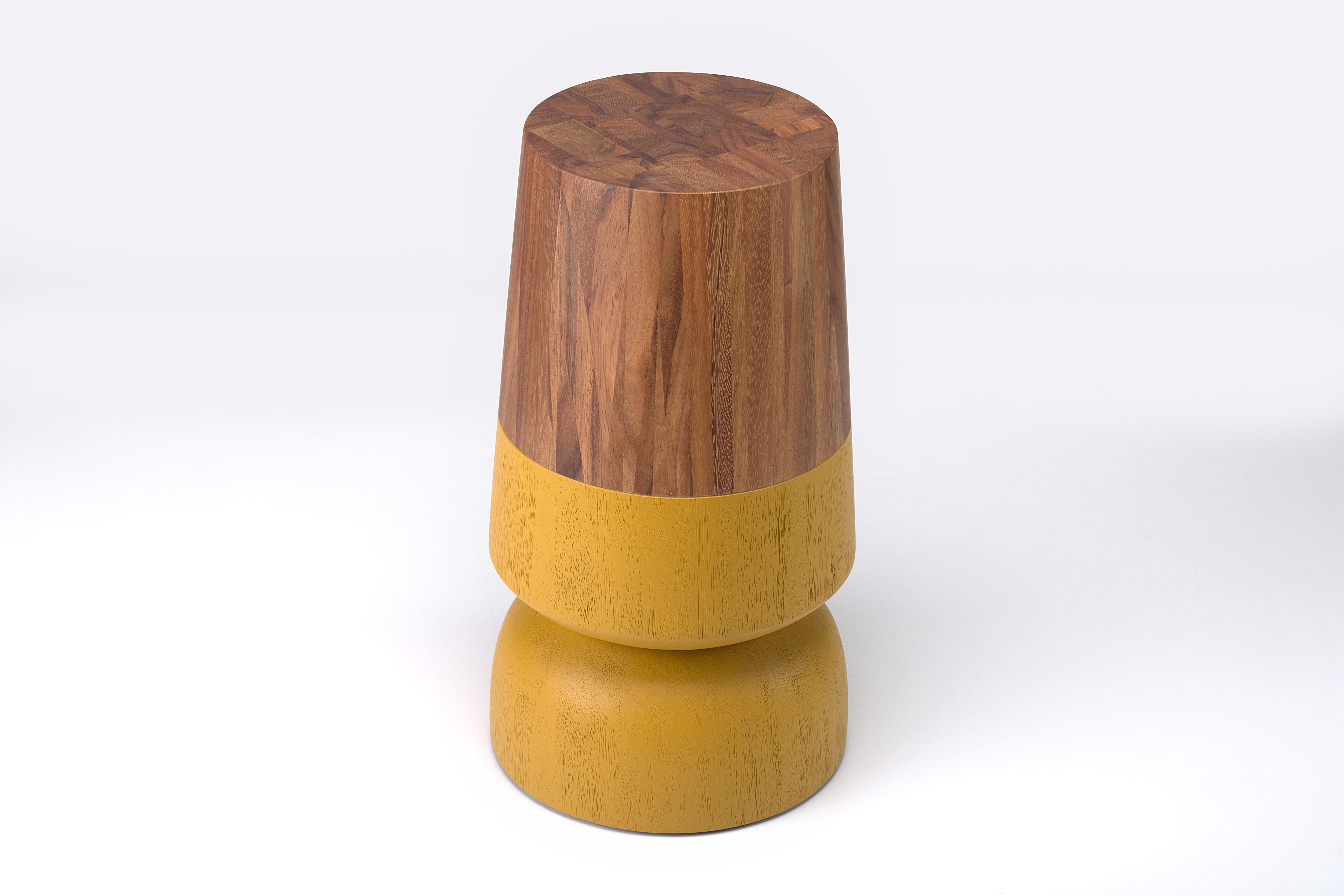Solid wood turned side table made out of solid conacaste and brushed mustard accents

The capirucho side table and stool are inspired by a popular yet simple toy enjoyed for many generations by kids in Guatemala. The piece has a playful silhouette