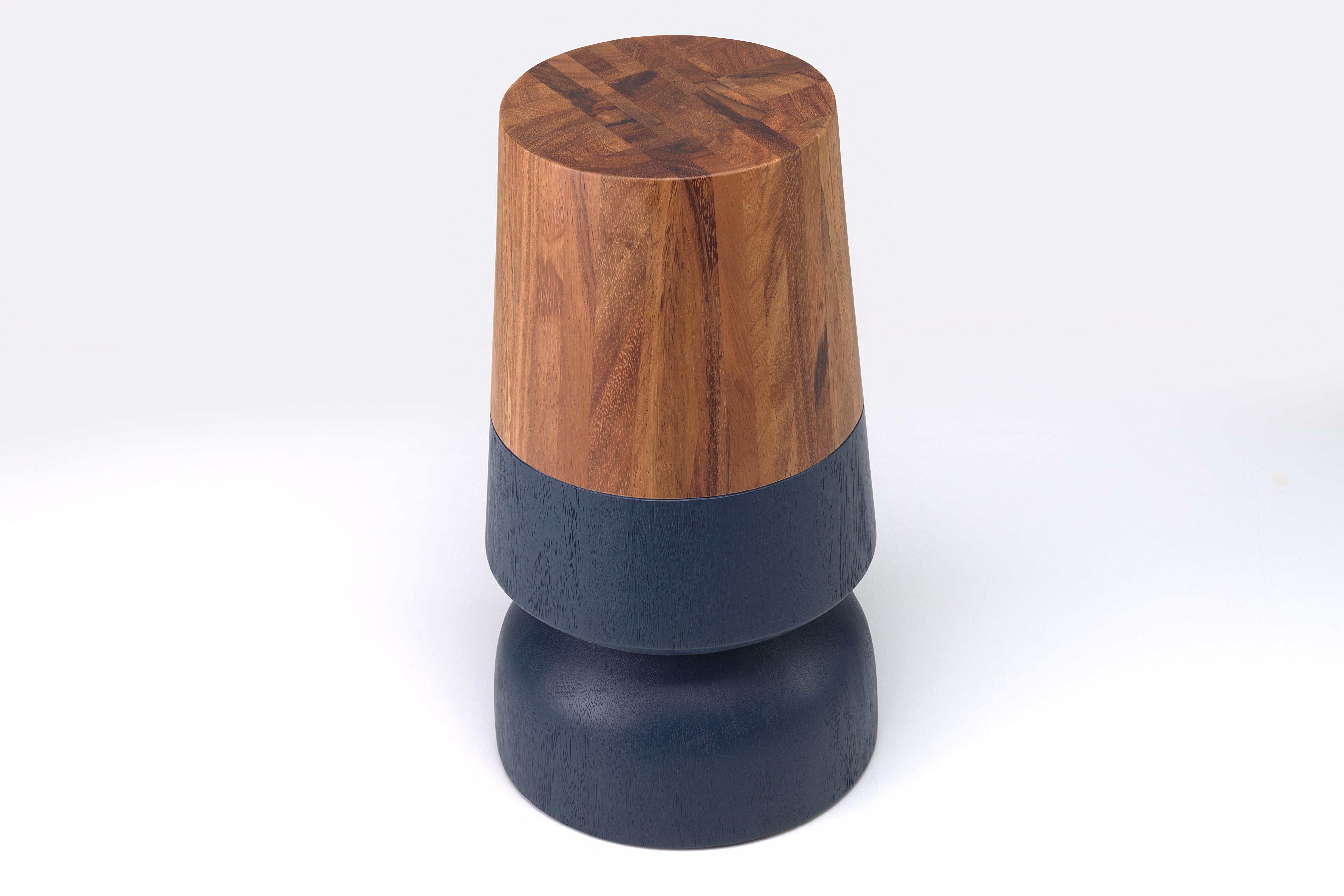 Solid wood turned side table made out of solid conacaste and brushed mustard accents

The capirucho side table and stool are inspired by a popular yet simple toy enjoyed for many generations by kids in Guatemala. The piece has a playful silhouette