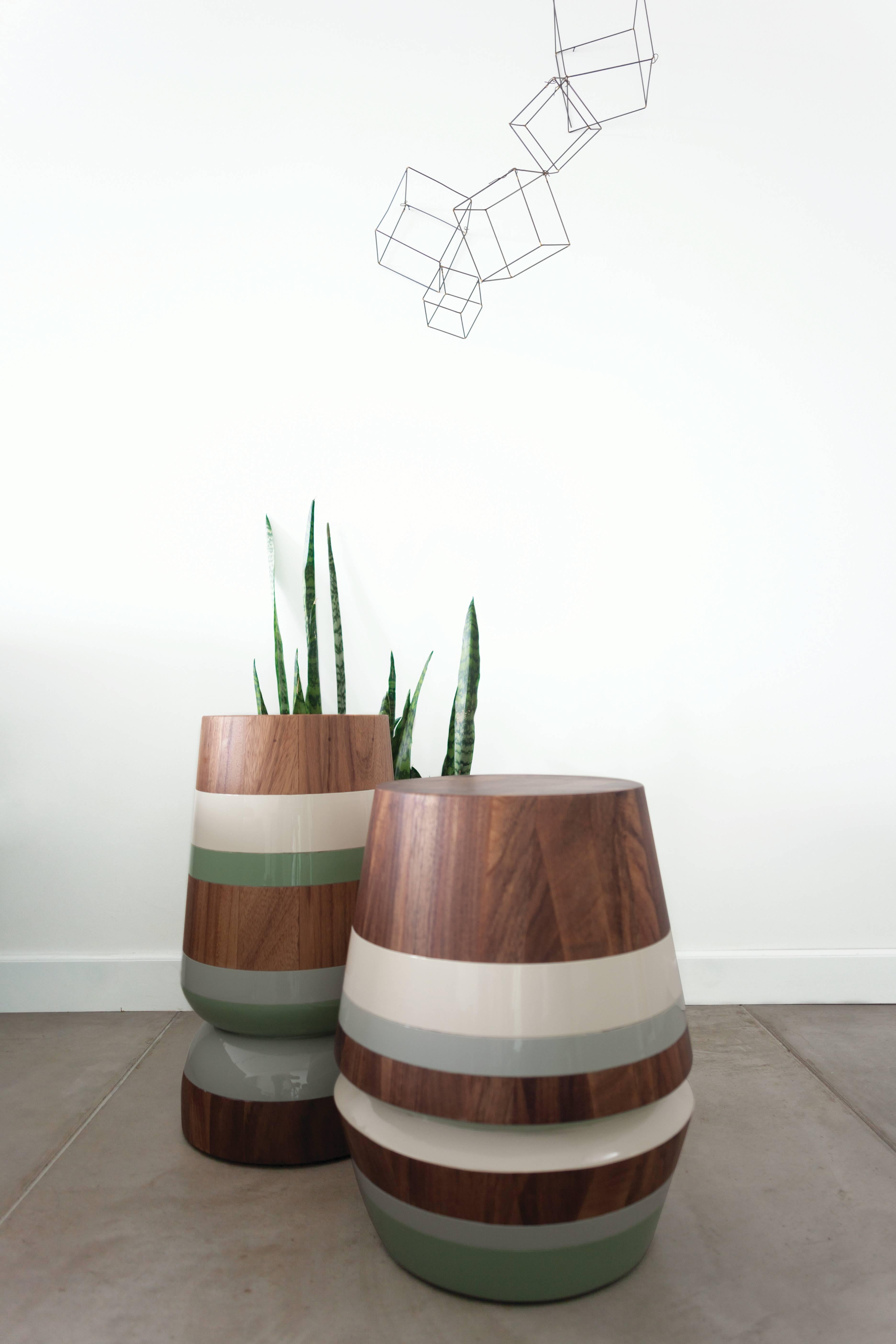 The capirucho side table and stool are inspired by a popular yet simple toy enjoyed for many generations by kids in Guatemala. The piece has a playful silhouette turned with conacaste, and it can be accentuated with colorful bands creating a more