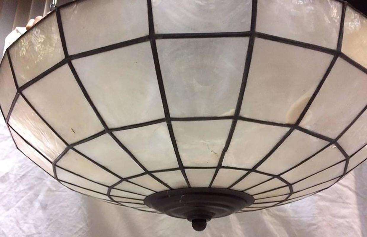 A circa 1960's French semi-flush mounted capiz shell ceiling fixture with four interior candelabra lights.

Measurements:
Diameter: 16