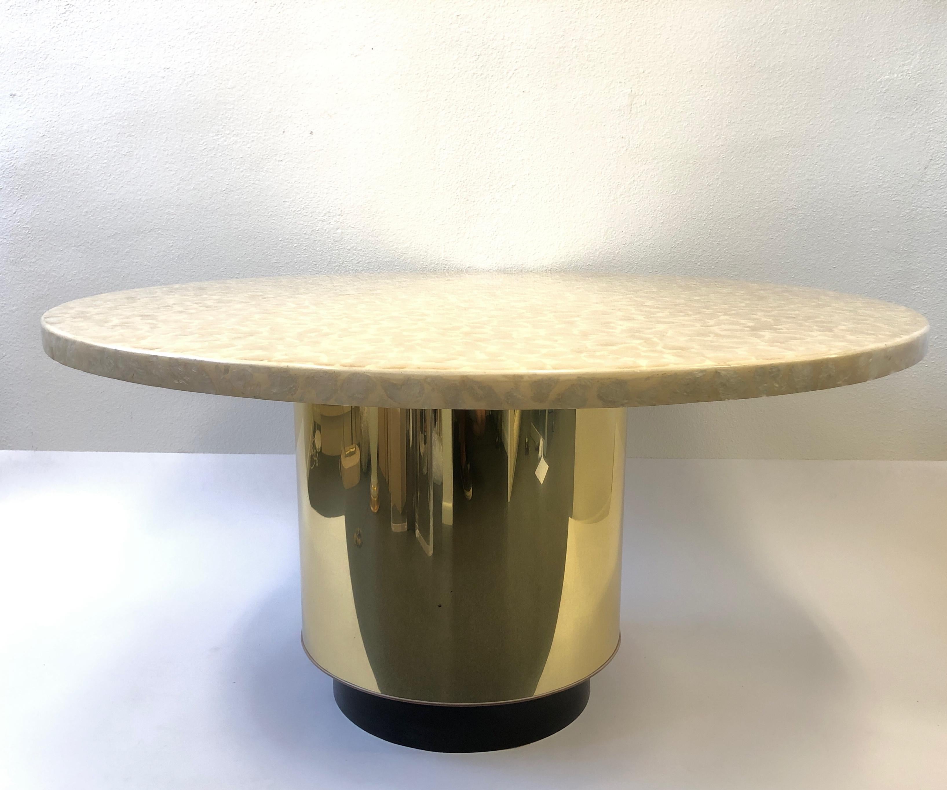 A beautiful 1960s Capiz Shell and polish brass dining table by Arthur Elrod. The table came out of a Arthur Elrod house in Rancho Mirage CA. The table shows minor wear consistent with age(see detail photos). The top is wood covered with capiz shell