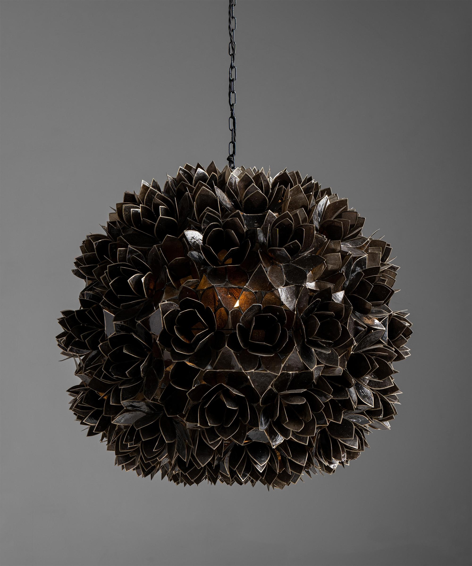 Capiz shell pendant,
France, circa 1960

Black capiz shells with tin armature, forming a series of flowers.

Measures: 24.5” diameter x 27” height

$ 7,200.

 