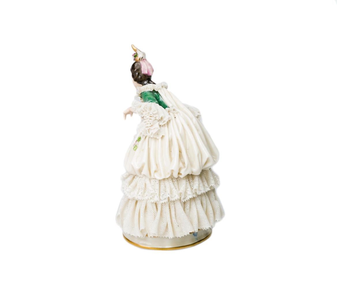 Squisita statuetta in porcellana di Capodimonte dell'inizio del XX secolo che raffigura una dama barocca vestita di pizzo a strati con abbellimenti floreali.

Realizzata a mano in Italia intorno al 1900, questa scultura in porcellana traslucida a