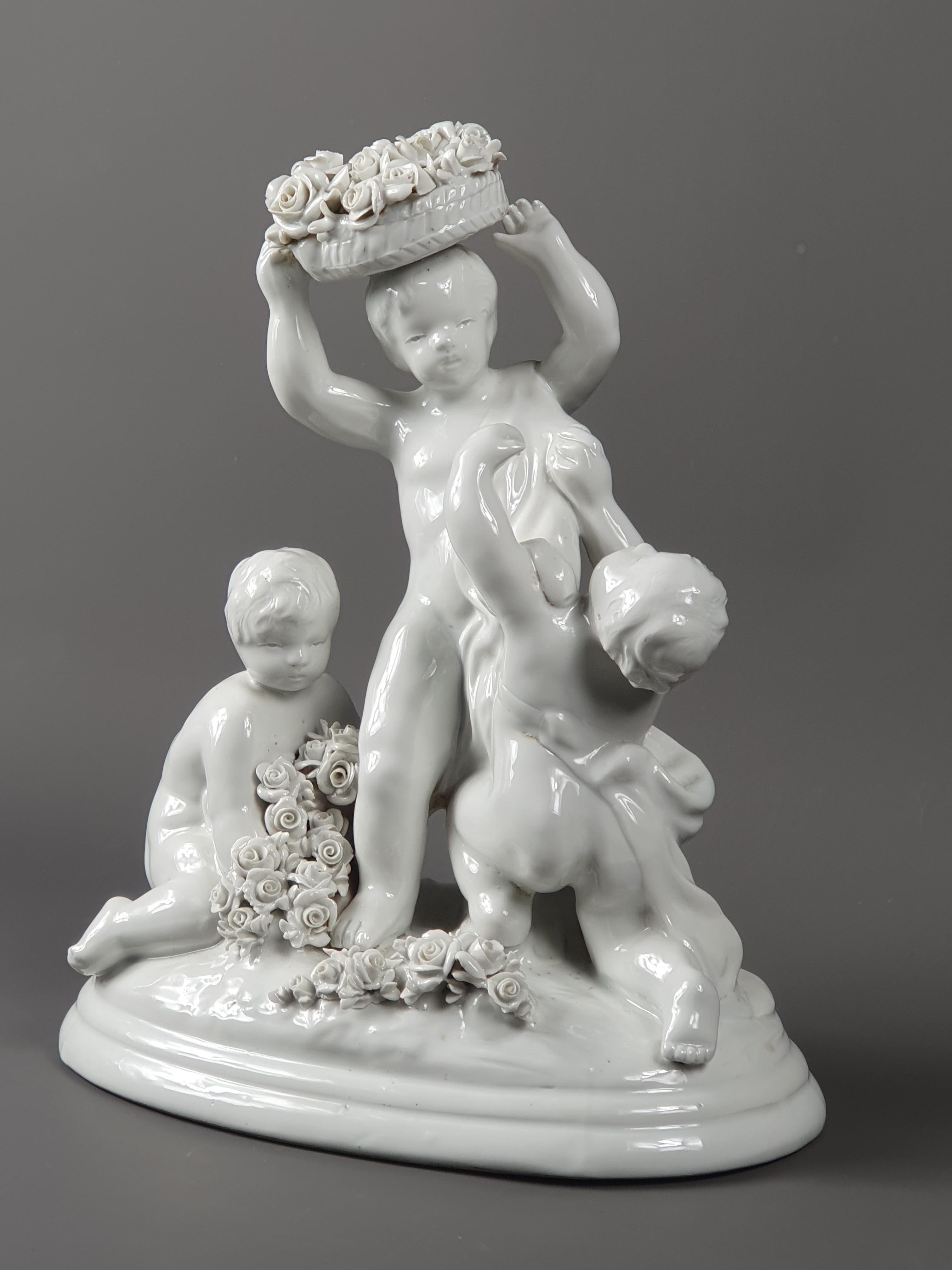 Capodimonte factory in Italy near Naples.

Enamelled porcelain group presenting three putti playing with sheaves of rosebuds, one of them carrying a basket on his head.

Signed L Badessi and stamp of the Capodimonte factory. Late 19th
