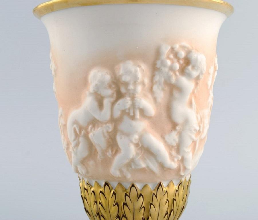 Italian Capodimonte, Italy. Antique porcelain vase with putti in relief. Early 20th C. For Sale