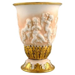 Capodimonte, Italy. Antique porcelain vase with putti in relief. Early 20th C.