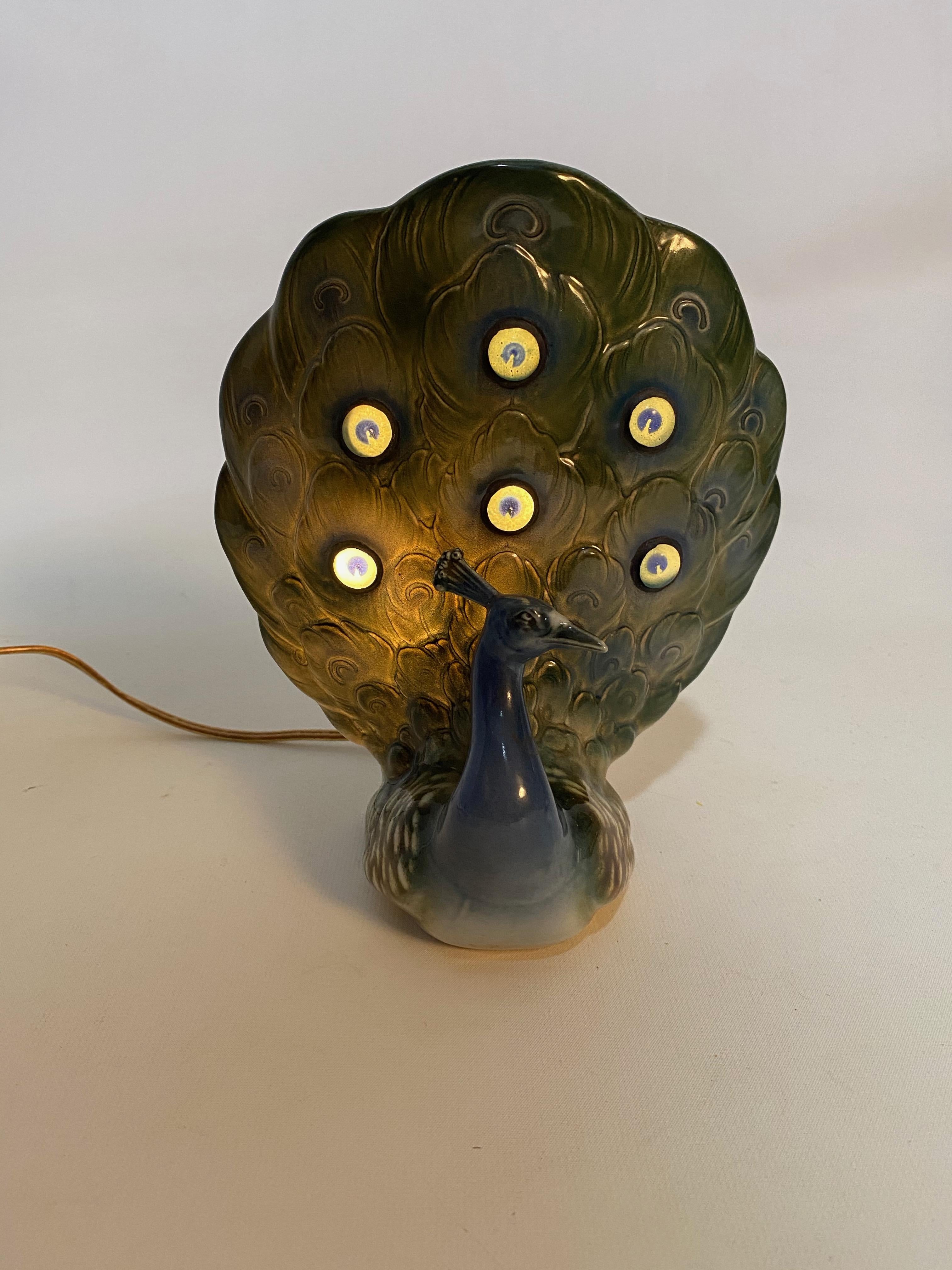 Signed Capodimonte jeweled paste porcelain peacock lamp. Wonderful elegant accent table lamp. Soft low light, circa 1960-1970. Original wiring in good condition. No visible chips, cracks or losses.

Approximately 4.5