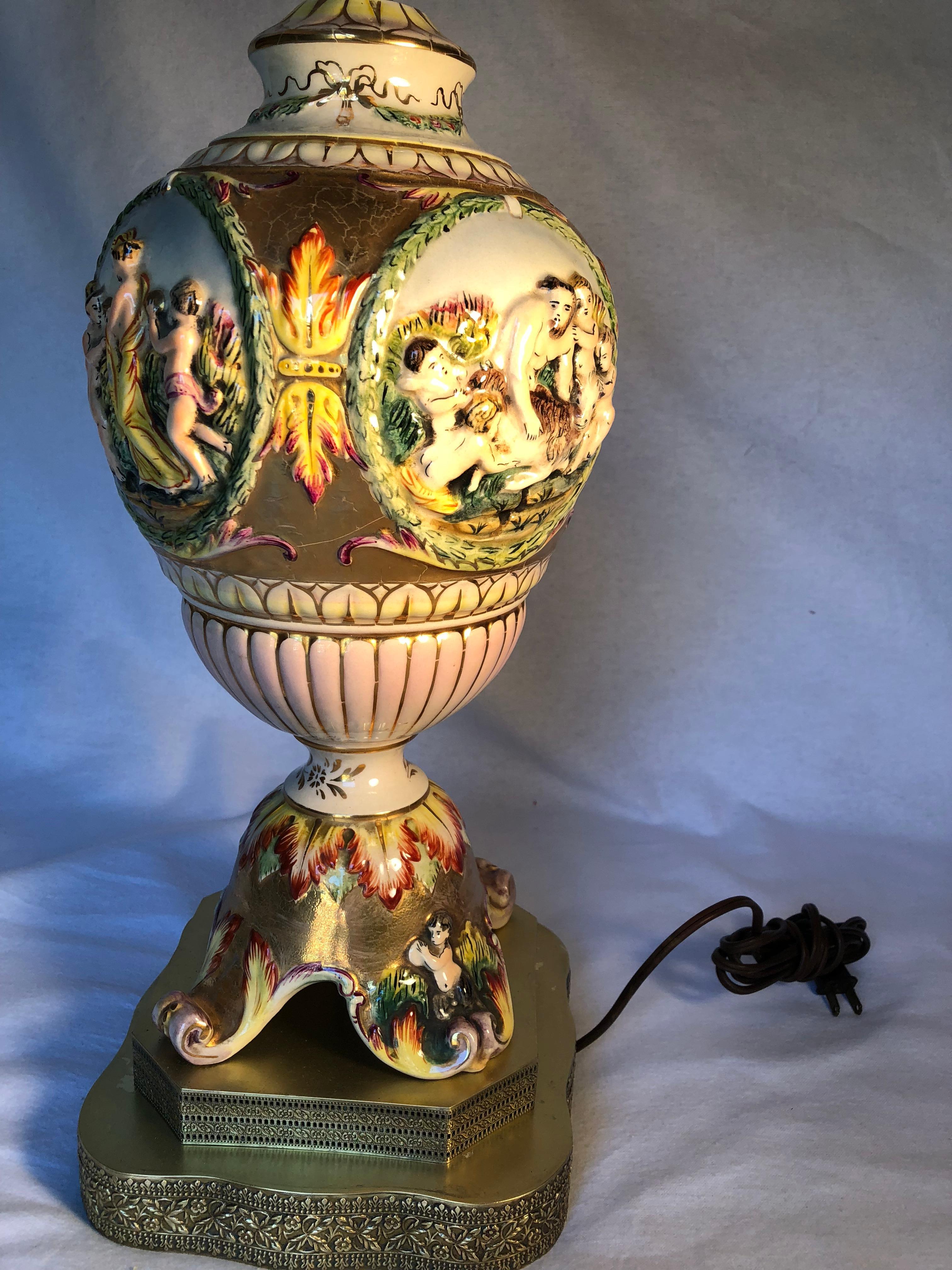 Beautiful 19th century Capodimonte lamp. I think the shade is a replacement. It is beautifully hand-painted and gold gilded with an intricate solid brass base and finial.