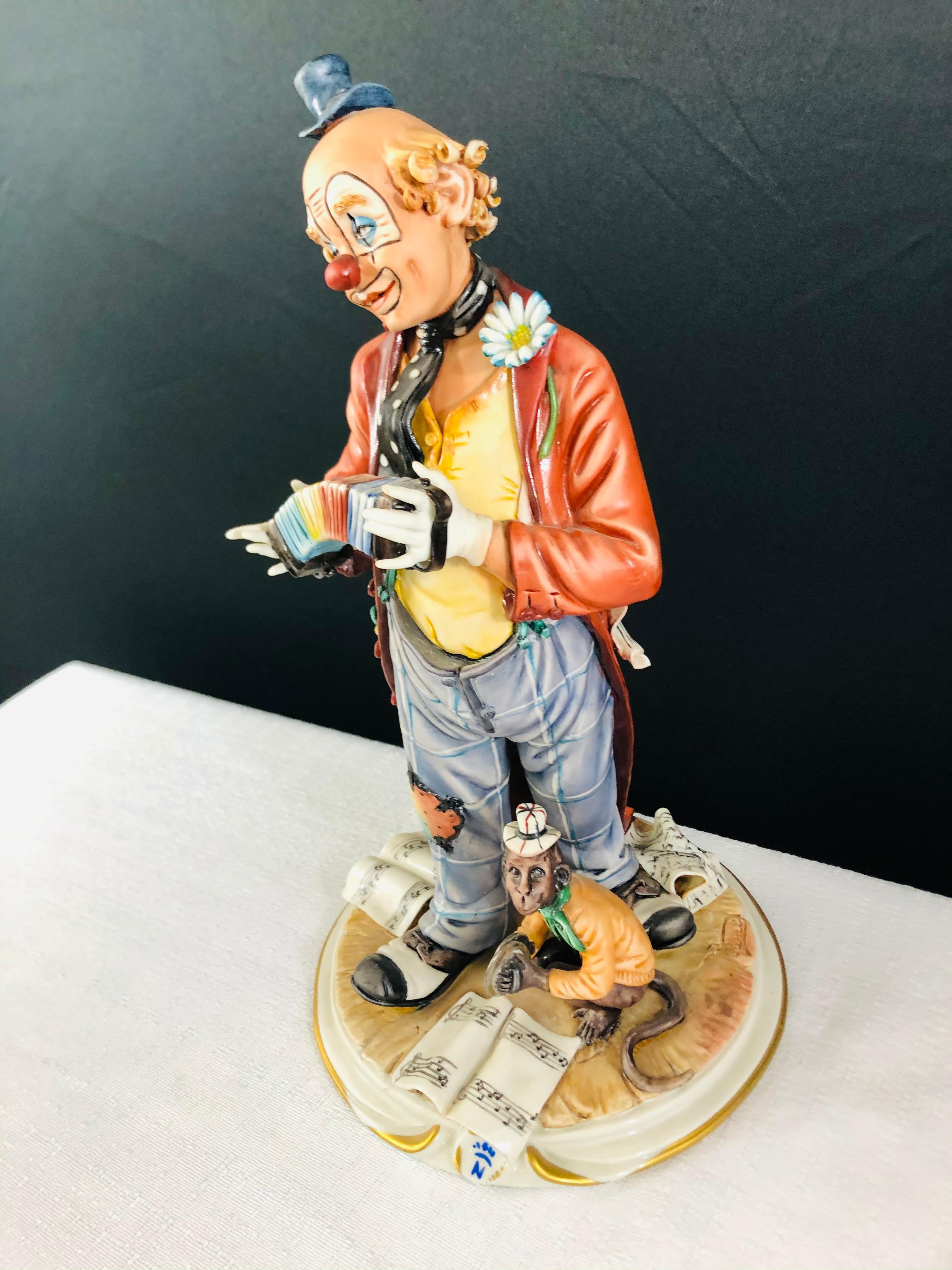 A stunning and very realistic sculpture by Capodimonte Medea by Rori of a clown playing accordion with his monkey featuring vibrant colors and intense detail.
A marvel for any collector. Made in Italy, the sculpture is signed by the