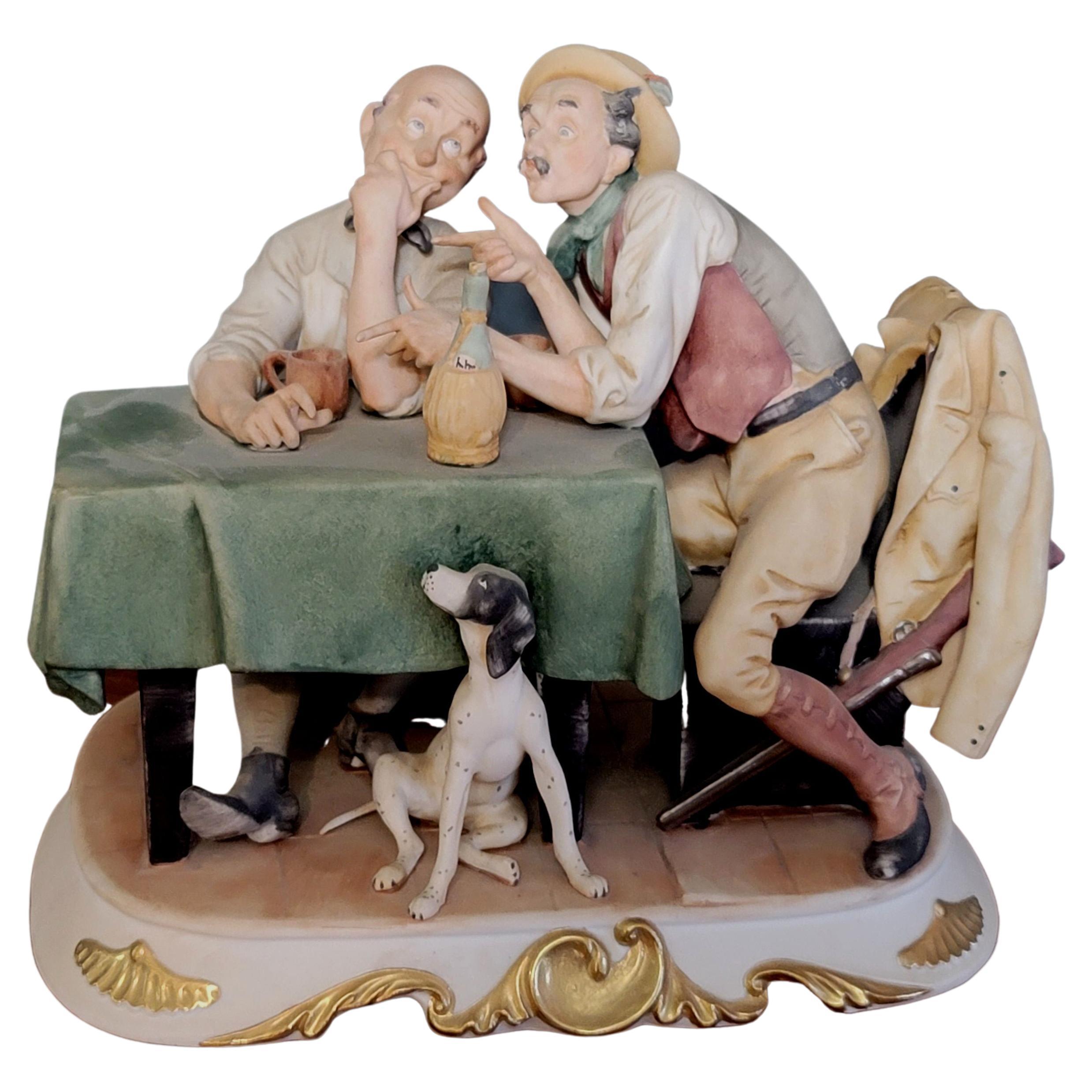 CAPODIMONTE porcelain figurine of two old men sitting at a table with a hunting dog by the table enjoying a bottle of chianti in perfect condition. 
The Item is about 8 1/2
