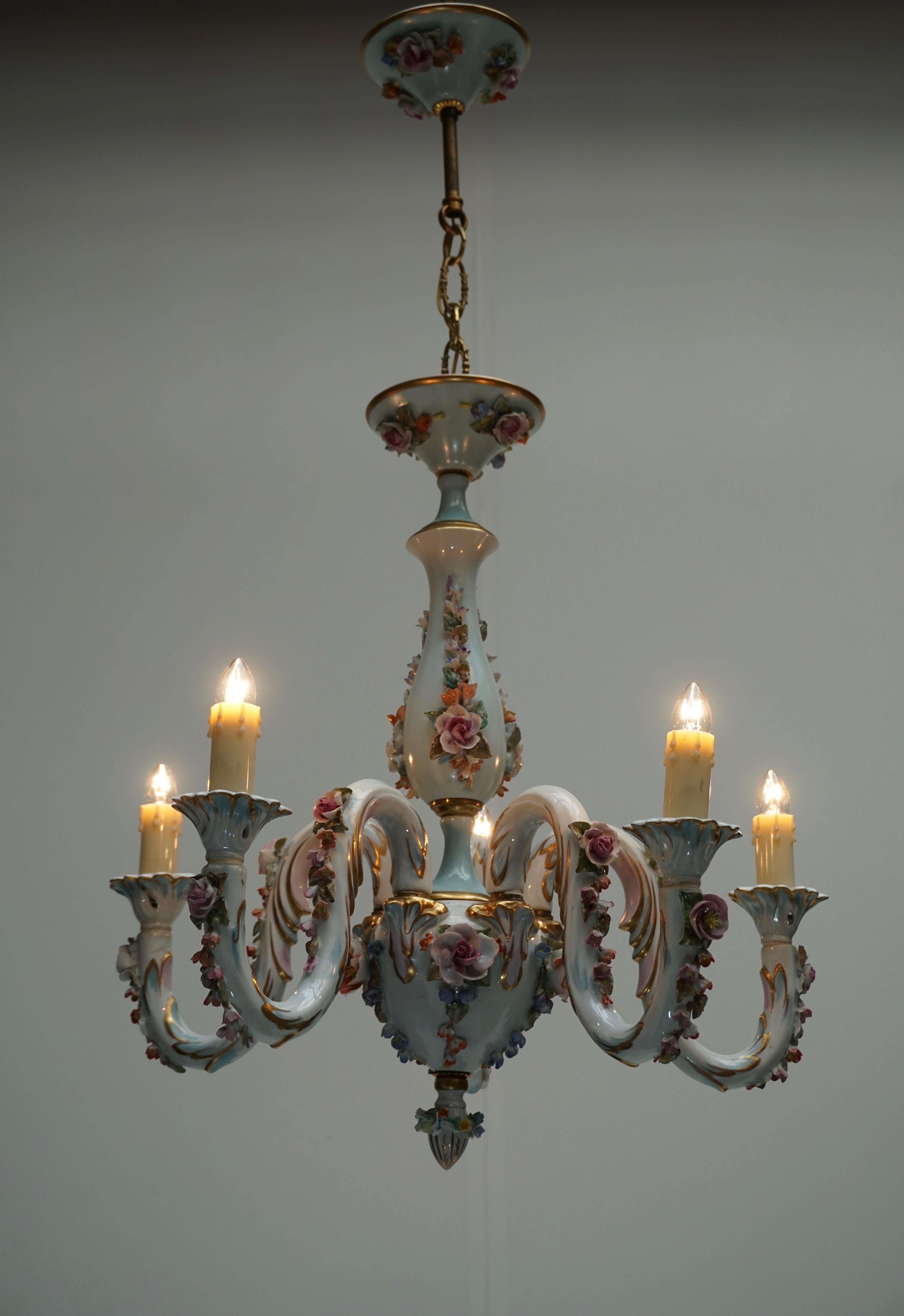 One of a kind magnificent porcelain chandelier exceptional quality crafted by the renowned Italian Capodimonte manufactory. This enchanting five lights porcelain chandelier is fully decorated with hand-painted flowers motif rendered in soft tones