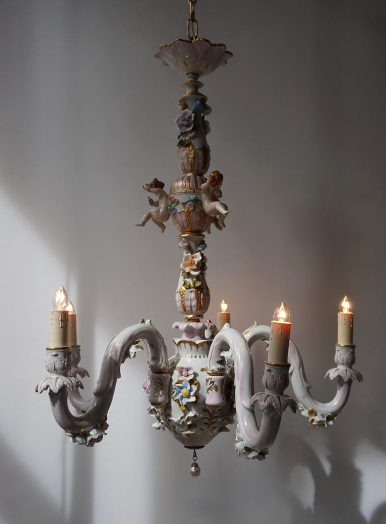One of a kind magnificent porcelain chandelier exceptional quality crafted by the renowned Italian Capodimonte manufactory. This enchanting five lights porcelain chandelier is fully decorated with hand-painted putti and flowers motif rendered in