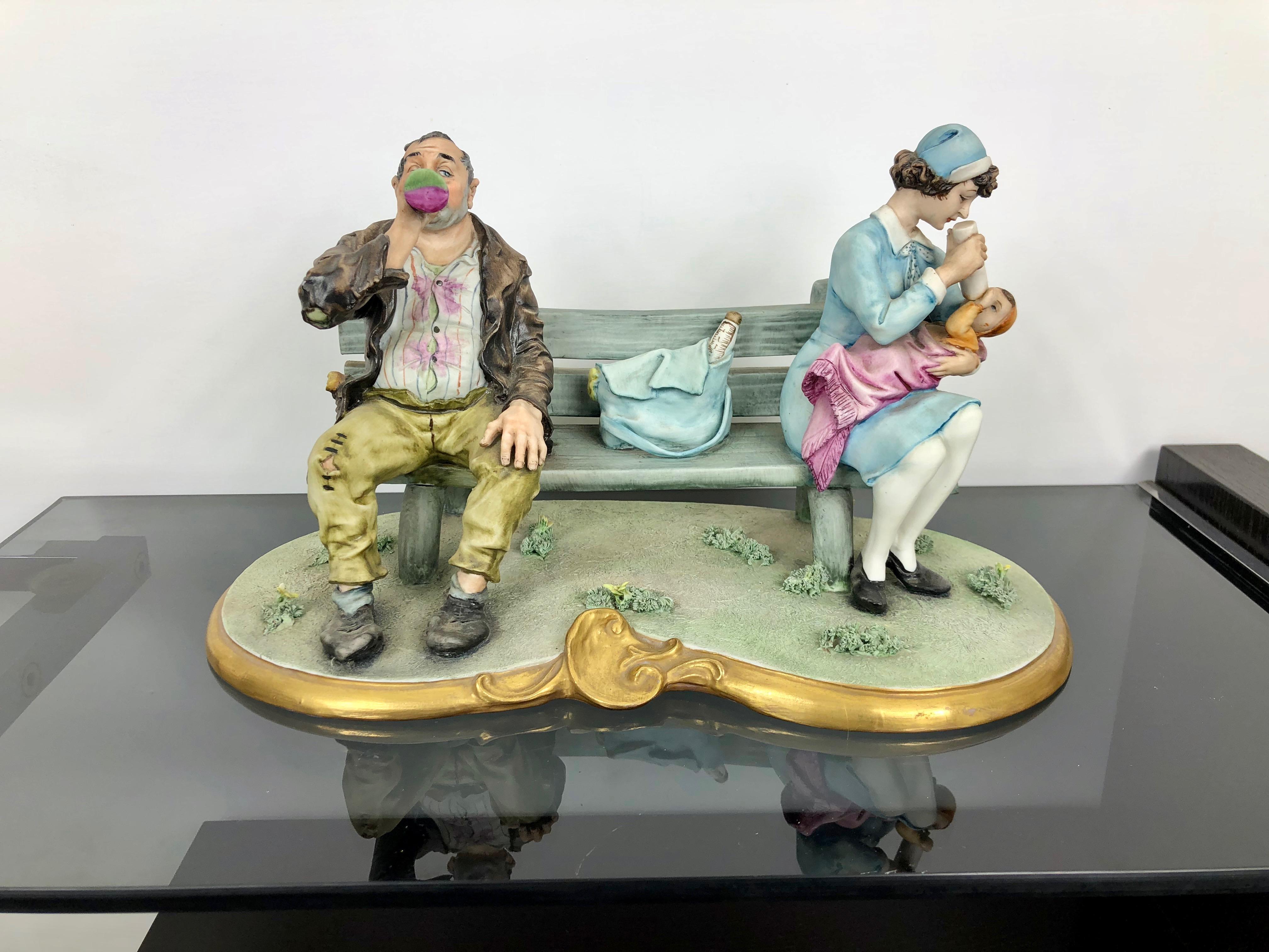 Splendid porcelain sculpture representing a tramp and a nanny feeding a child far from each other on a bench. Signed on the bottom with its original stamp 